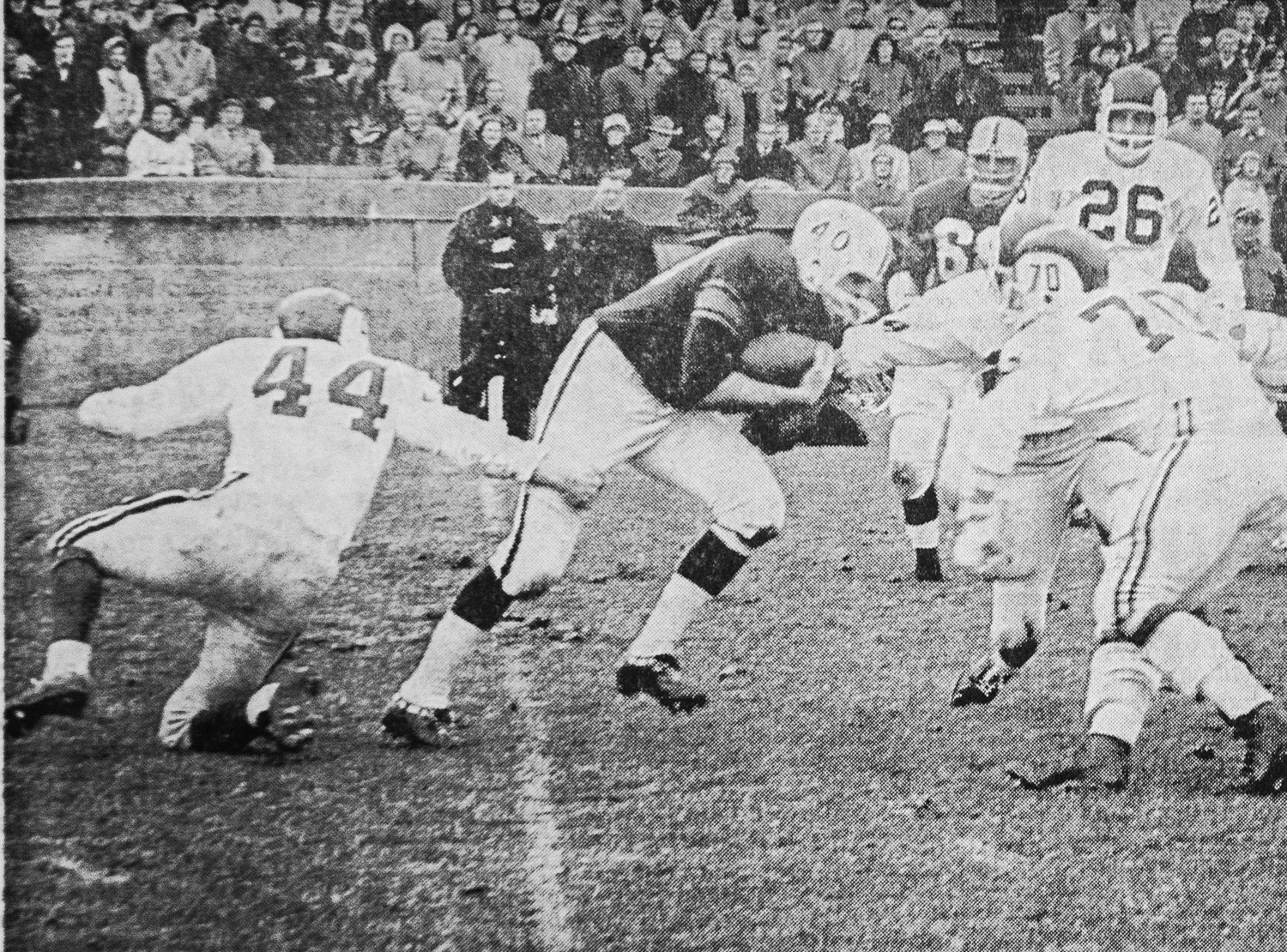 Yale's Bill Henderson (40) runs into Crimson opposition during the second period of the 1963 Harvard-Yale game, as John P. Dockery ‘66 (44), Jack L. Neuenschwander ‘64 (70), and Rick L. Beizer ‘64 (26) converge on the Eli halfback. This photograph from the New Haven game, which was rescheduled for November 30 after the Kennedy assassination, ran in the Monday, December 2, 1963 issue of The Crimson.