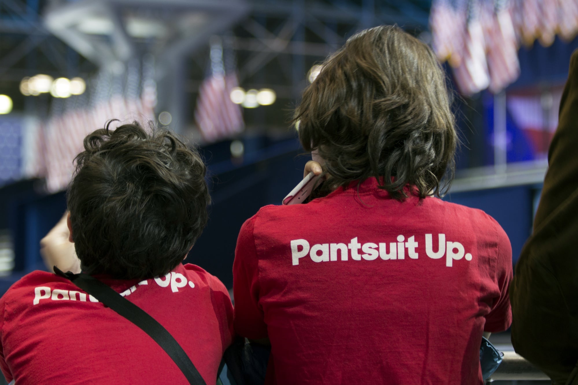 Two young Hillary Clinton supporters eagerly await the voting results at the Javits Center in New York City during the 2016 election night. In a political upset, Clinton would eventually lose the presidential race to Republican opponent Donald Trump.