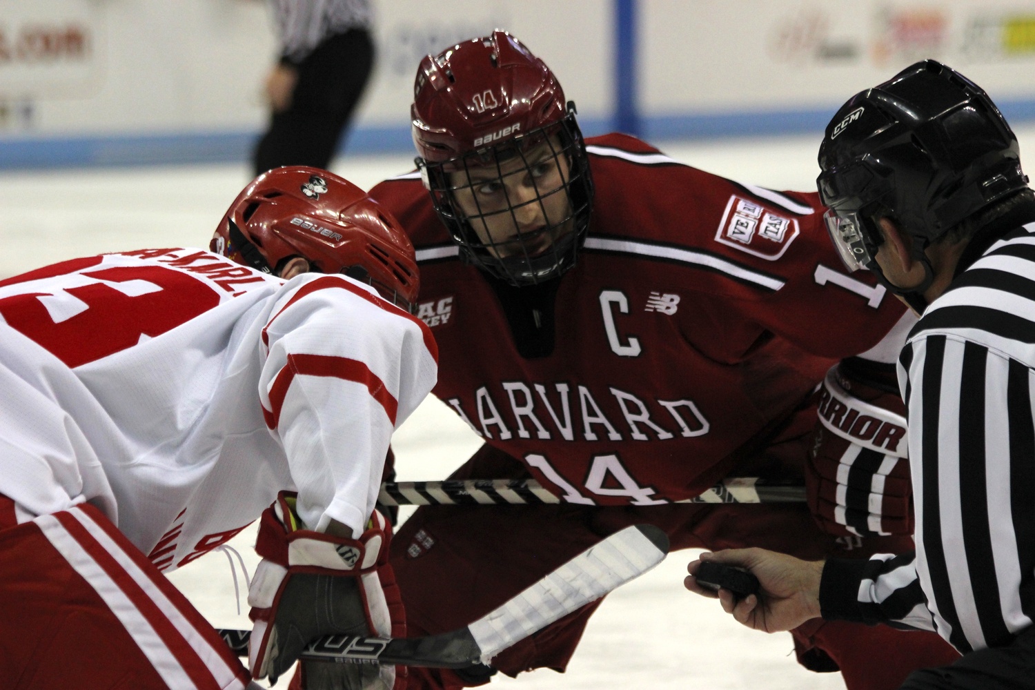 Co-captain Alexander Kerfoot takes a faceoff at BU.