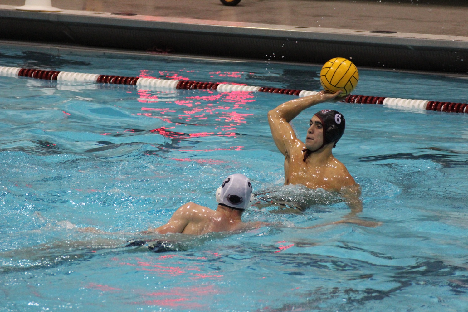 Grayson C. Judge '19 gears up to toss the ball during a game against MIT last month. The men's water polo team won their first NCAA championship game Saturday.