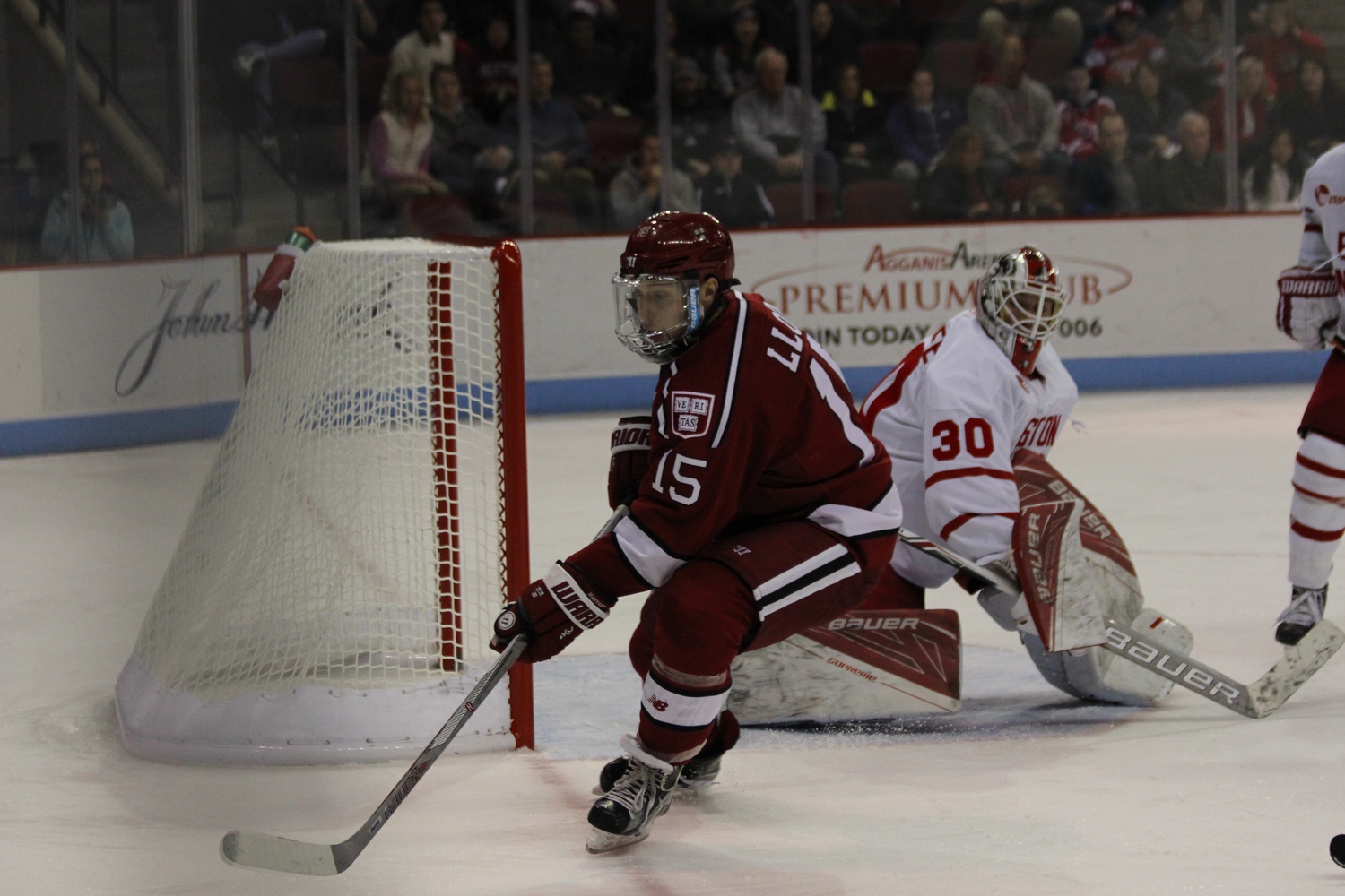 B. Seb Lloyd '18 chases a puck at a game against Boston University Tuesday. Harvard lost 3-5.