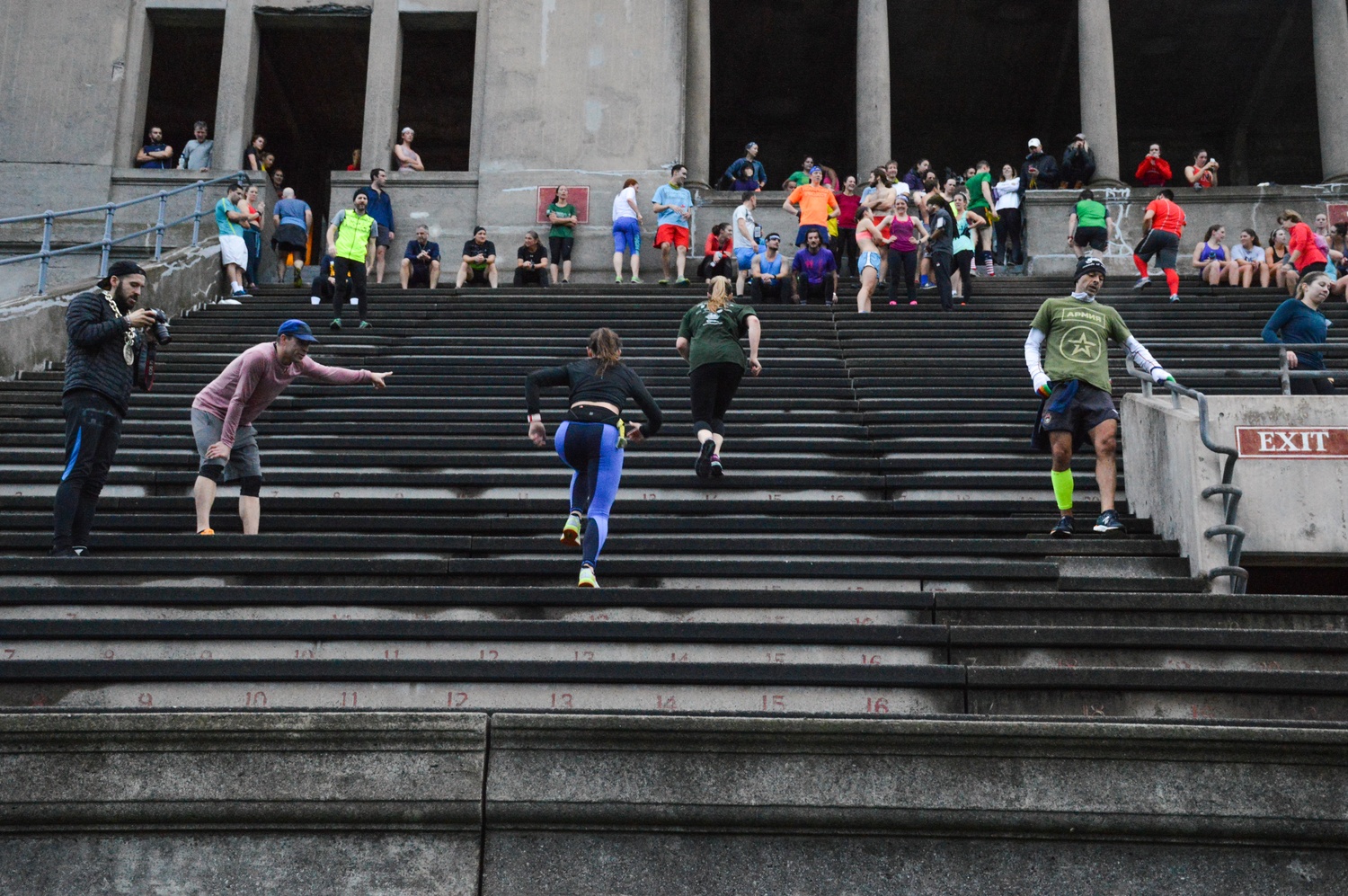 Organizers of the November Project cheer on runners as they approach the top of the last section of the stadium.