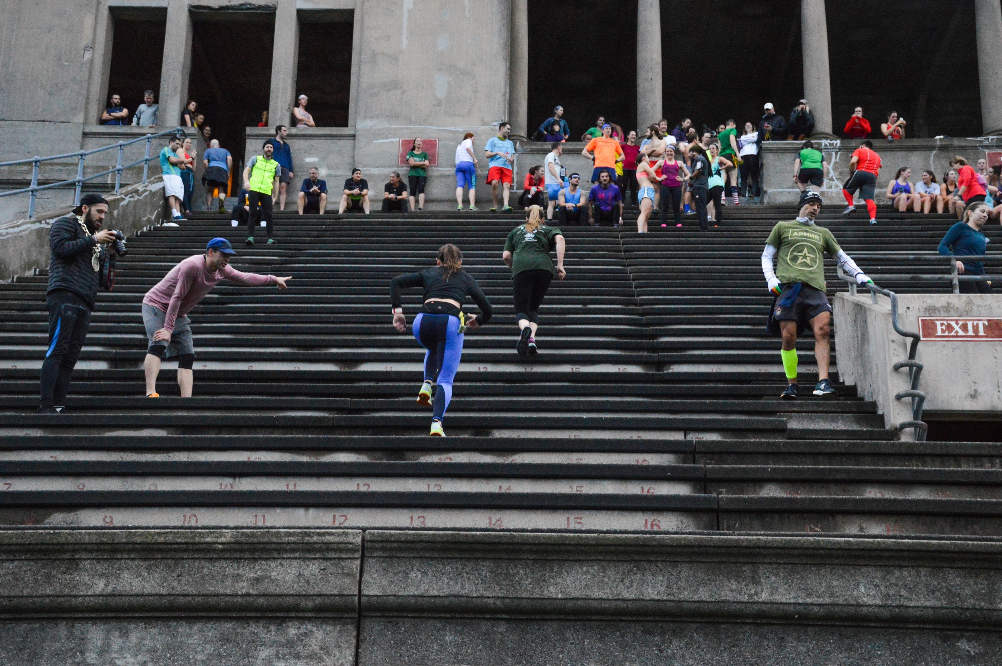 Organizers of the November Project cheer on runners as they approach the top of the last section of the stadium.