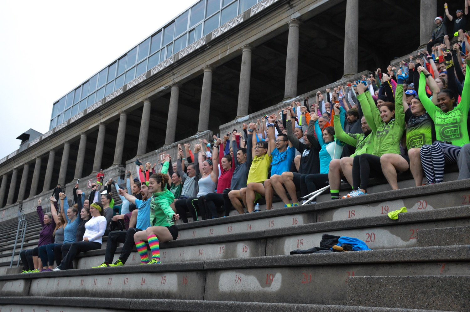 Chris R. Payne and Emily Saul lead in the November Project pose for a group photo at the end of Wednesday's run.