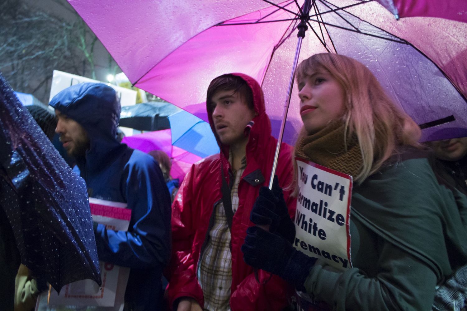 Attendees listen to a speaker during a protest against Trump administration members speaking on campus Wednesday.