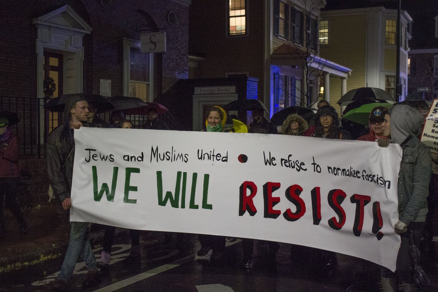 Protestors march down Mount Auburn Street to demonstrate against members of President-elect Donald Trump's administration speaking on campus.