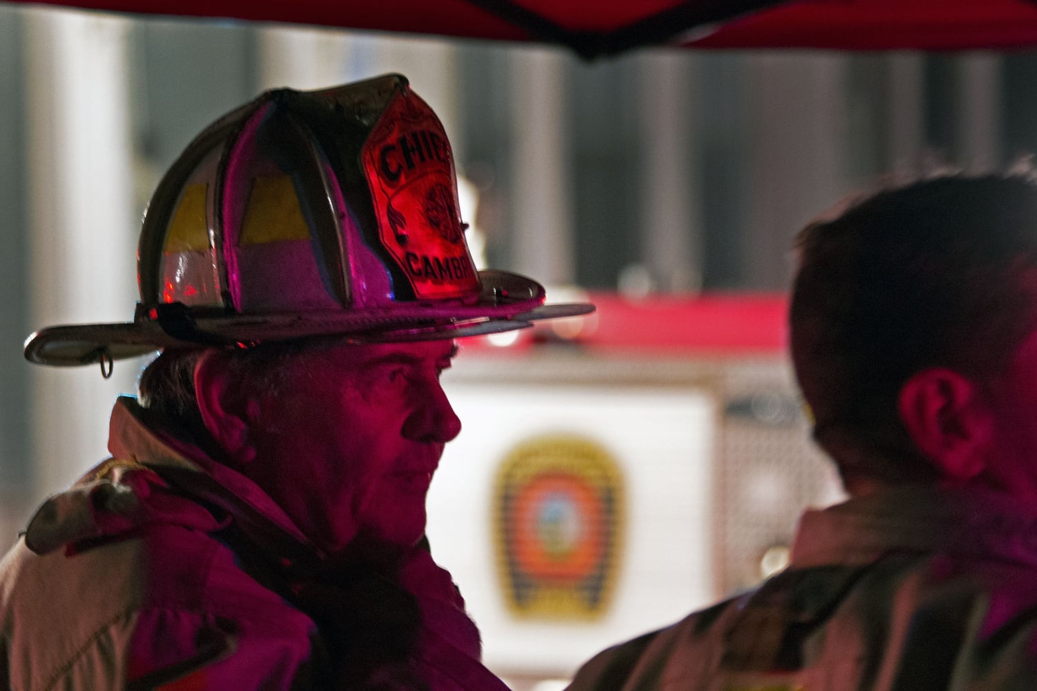 Cambridge Fire Chief Gerald Reardon monitors the active fire in Cambridge Saturday night. The blaze affected eight buildings, completely destroying some properties.