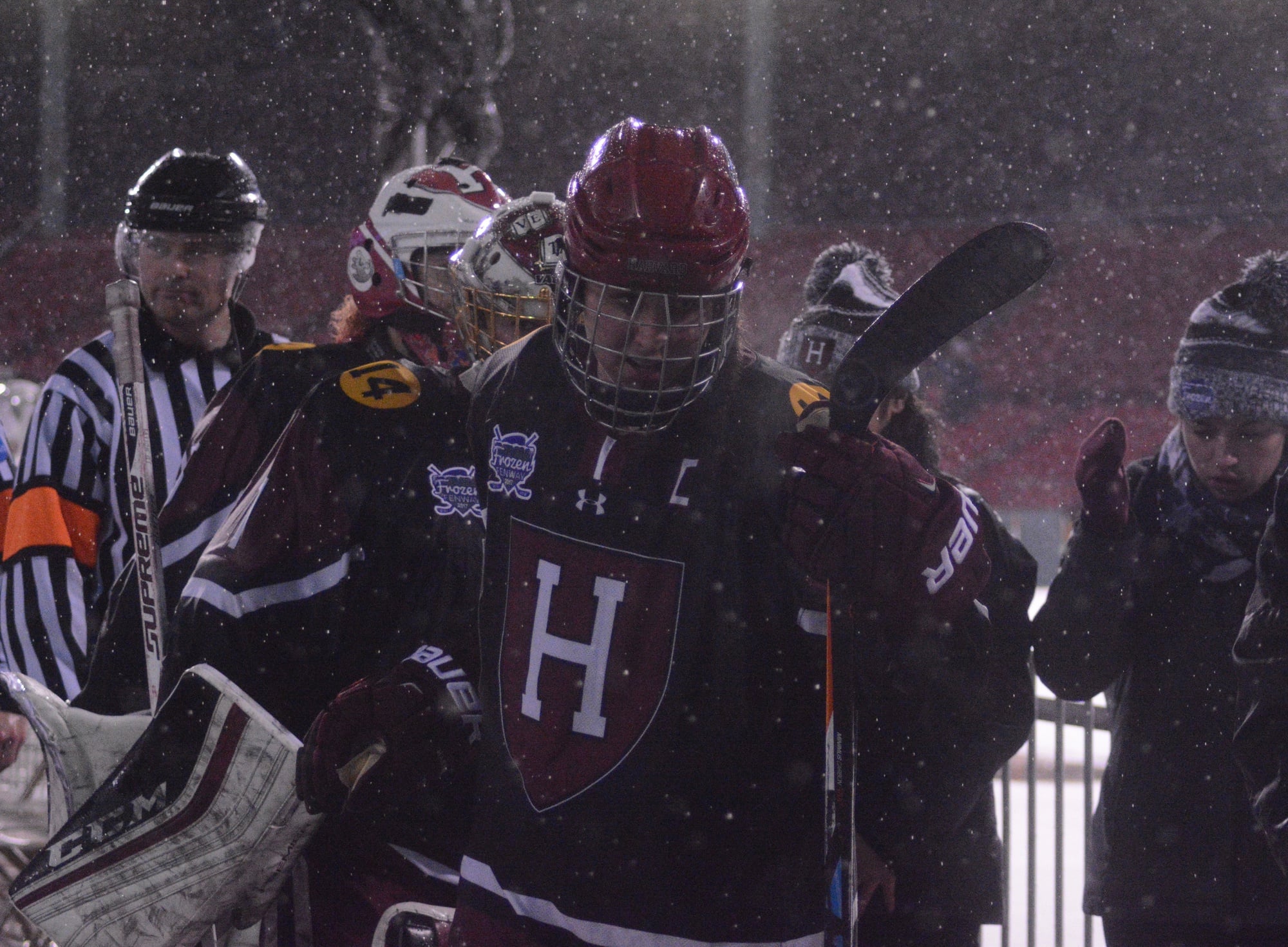 Senior co-captain Sydney Daniels steps off the ice amid the downpour that persisted during Frozen Fenway. 