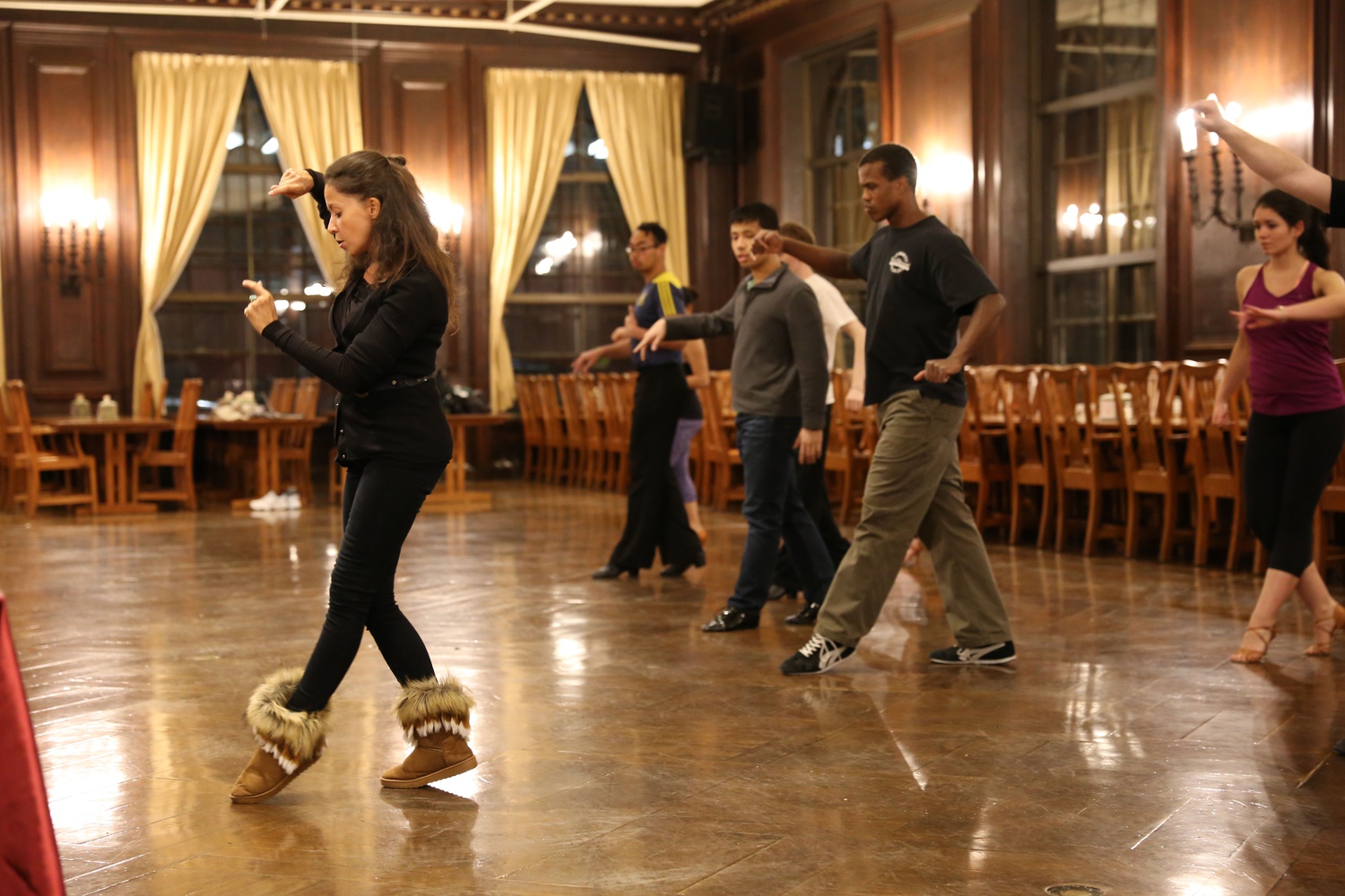 Olga Kinnard, a coach for the Harvard Ballroom Dance Team, teaches students during a free Wintersession dance lesson hosted by Harvard Ballroom in the Adams Dining Hall Wednesday night.
