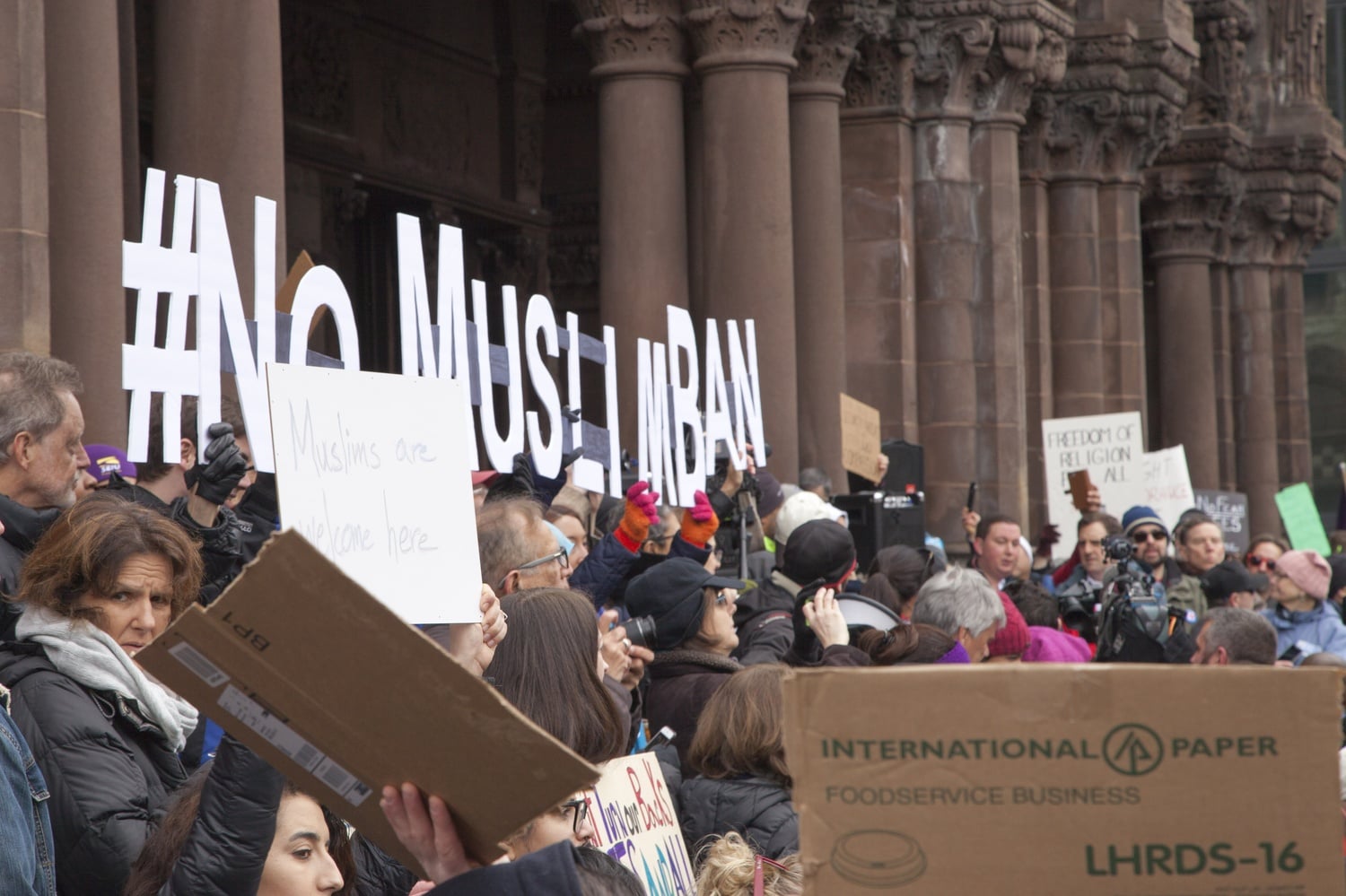 Demonstrators hold signs opposing President Donald Trump's immigration ban during a large rally in Boston's Copley Square on Jan. 29.