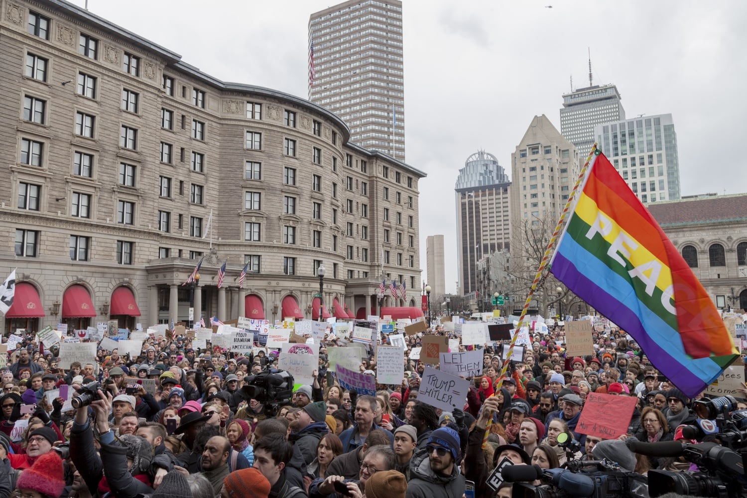 Brandishing signs and flags, crowds rally in Boston's Copley Square in January after President Donald Trump's immigration order.