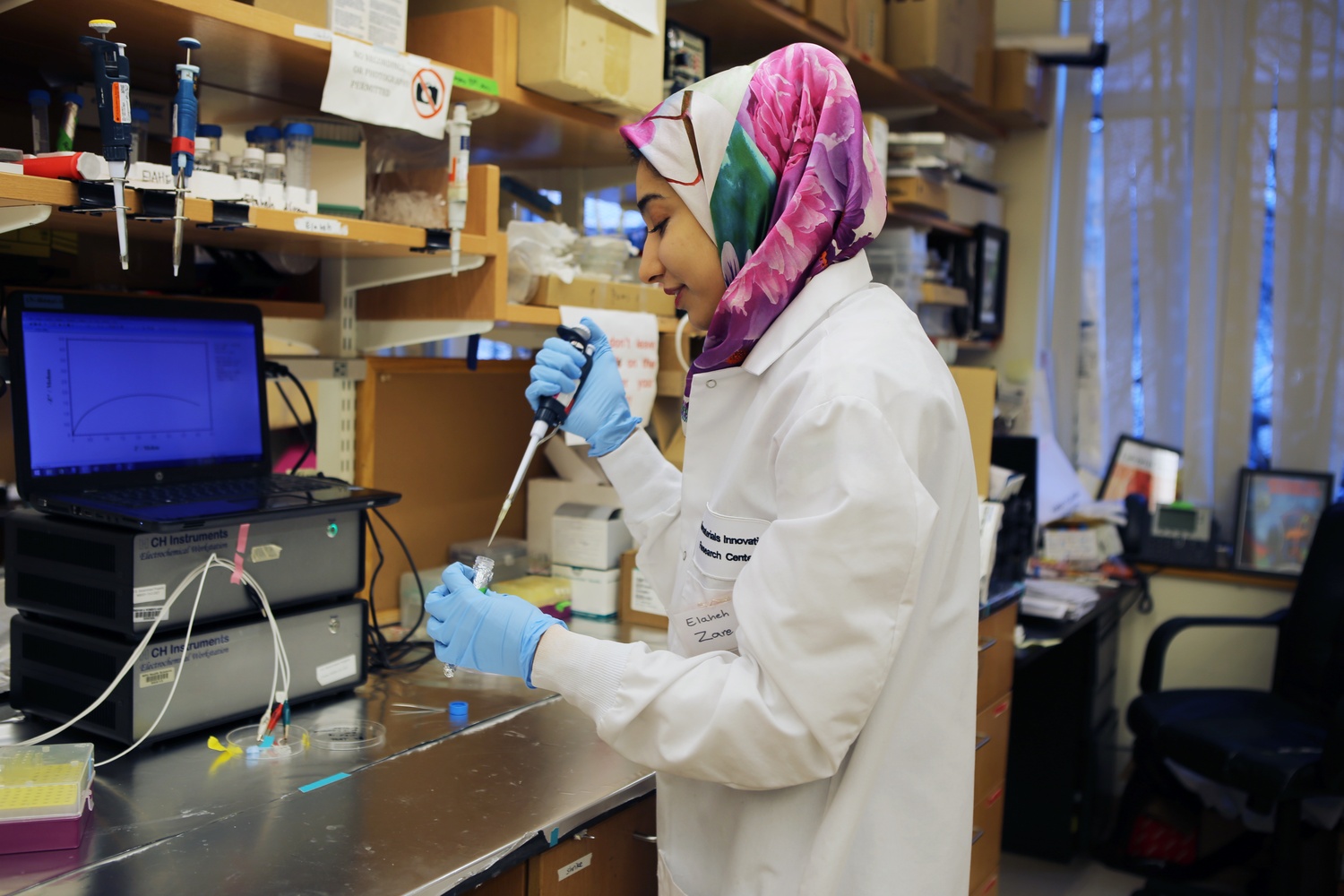 Elaheh Zare, an Iranian scientist in a lab studying anticancer drugs, says she would rather live in a place “where they respect other nationalities.”