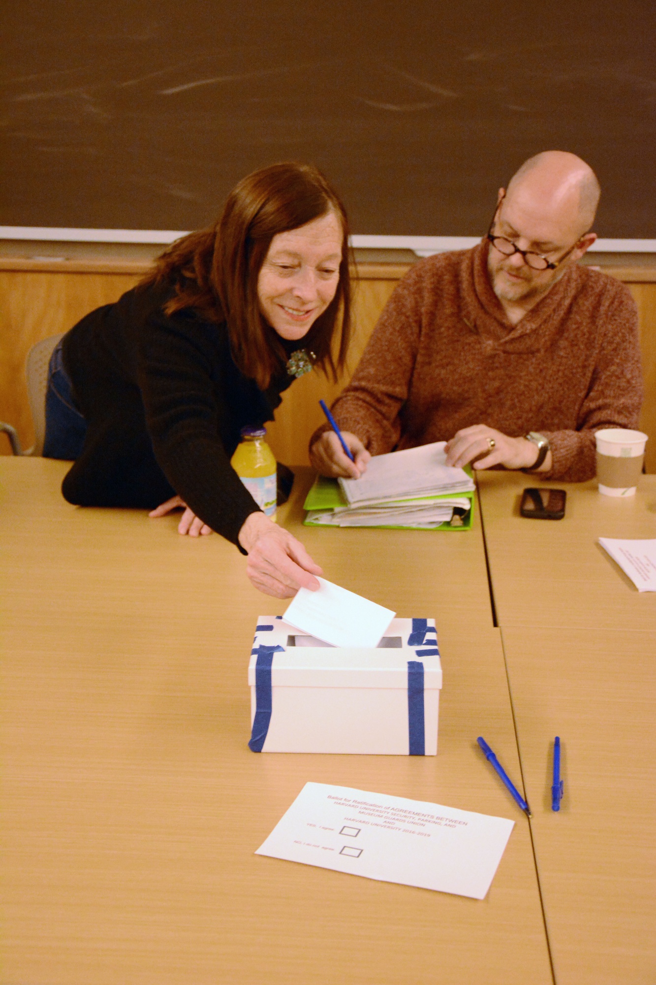 Museum attendant Patricia A. Daly votes to ratify the agreement between Harvard University and Harvard University Security, Parking and Museum Guards Union Tuesday night in Lamont Library.