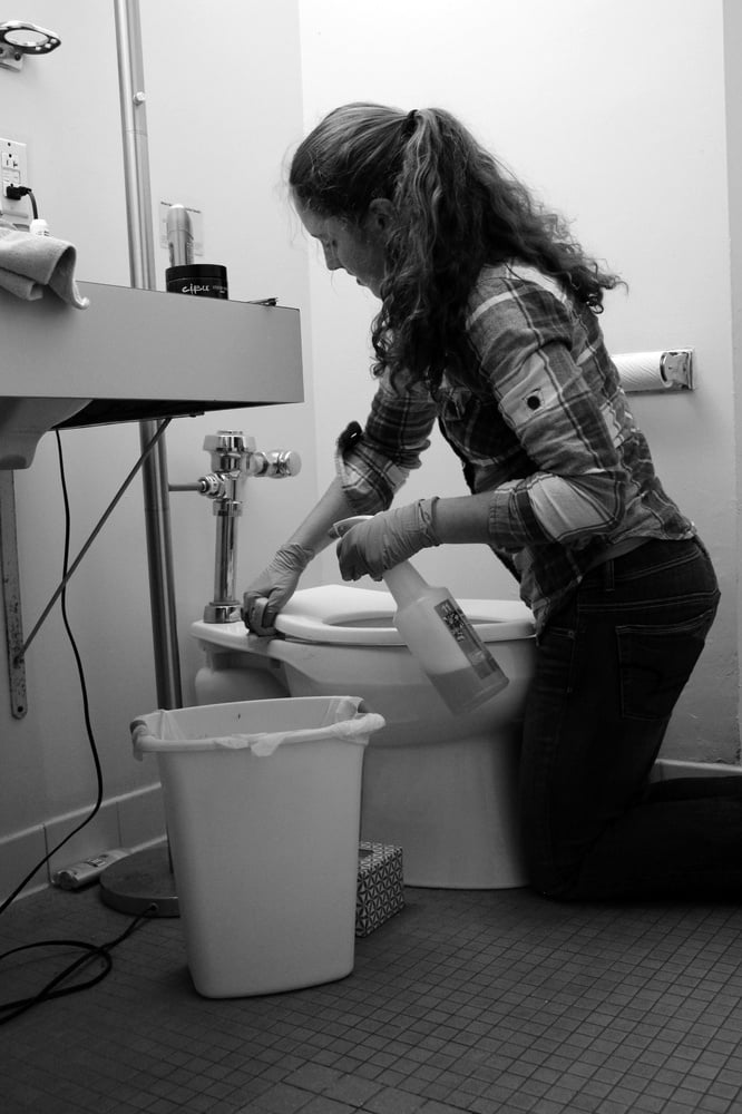 Sarah Lagan '19 cleans a toilet in Cabot House as a part of Dorm Crew.