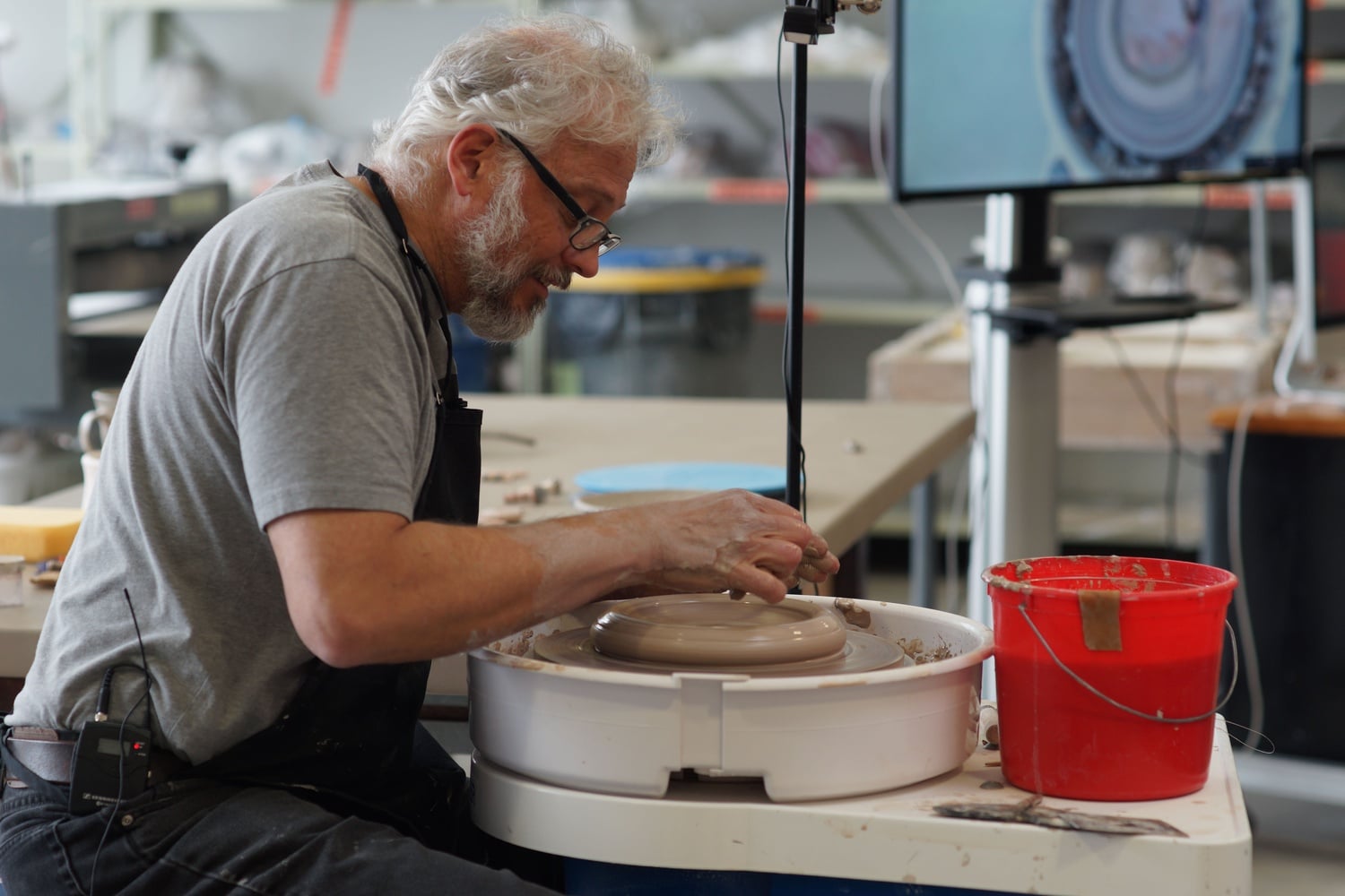 Potter Michael Kline works on a vase as part of a workshop that took place on Saturday. 