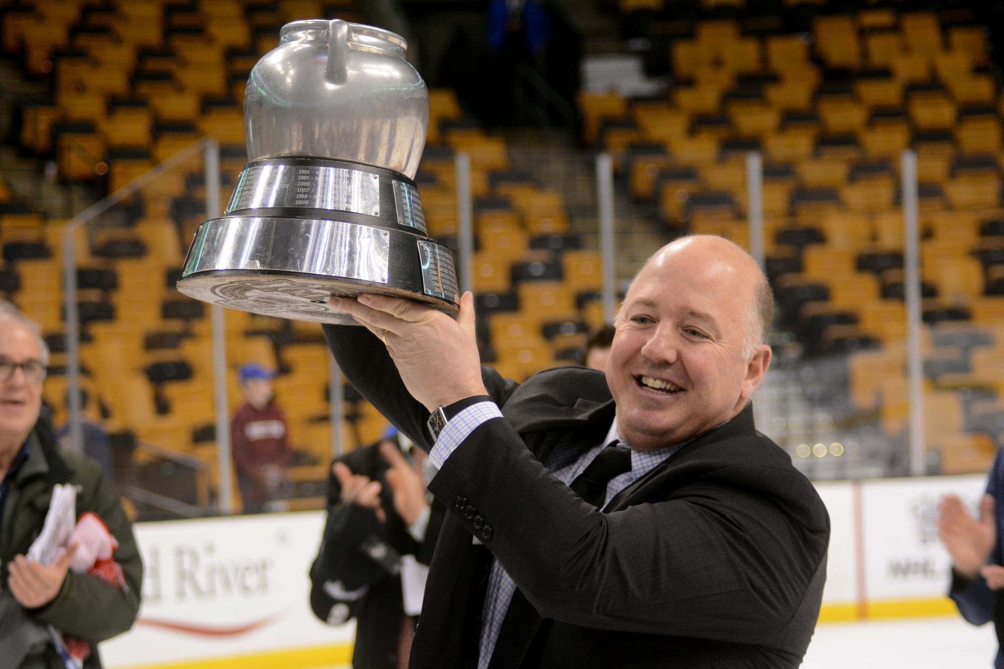 Harvard coach Ted Donato hoists the Beanpot Trophy following the Crimson's victory over Boston University at TD Garden. Donato, now in his 13th season behind the Harvard bench, now has won one Beanpot as a player and one as a coach.
