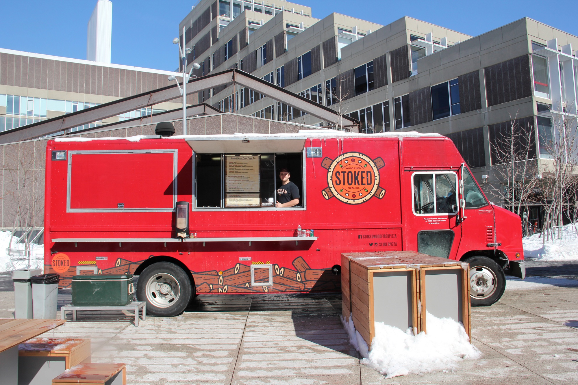 Ryan Mailhot, of Stoked Wood Fire Pizza Co., poses with his truck on Tuesday.