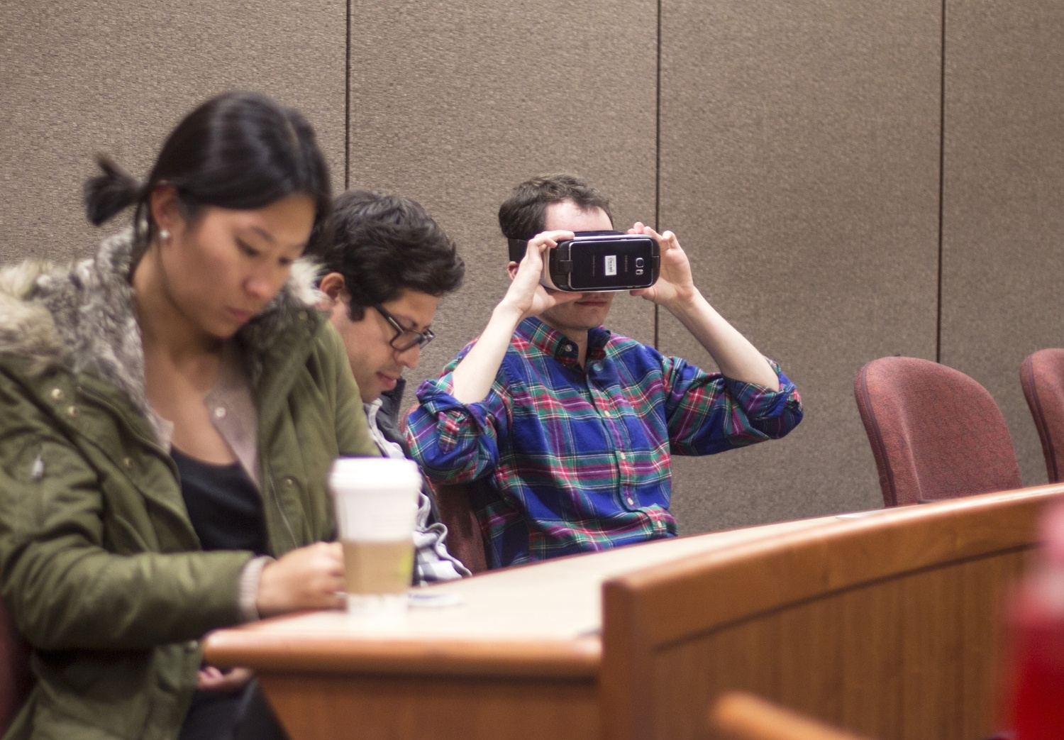  Students pass around a virtual reality headset to try on during a Harvard AR/VR Student Alliance event last Wednesday. The event, “VR and Entrepreneurship with _Underscore.VC” attracted over 30 attendees.