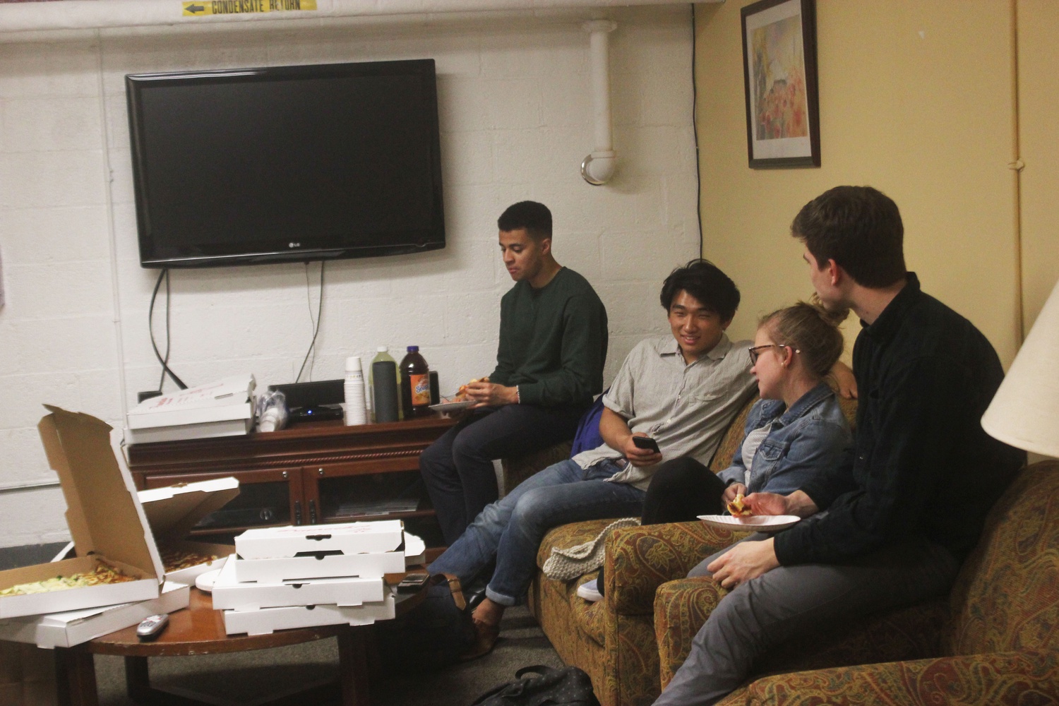 Students enjoy free pizza at study break hosted by Harvard College Healthcare Associates in Kirkland Thursday night. 