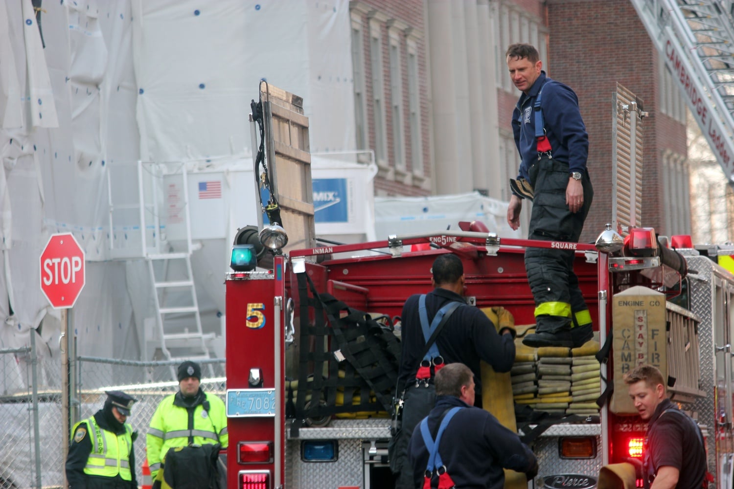 Firefighters work to extinguish a fire on the construction site at Winthrop House on Monday morning.