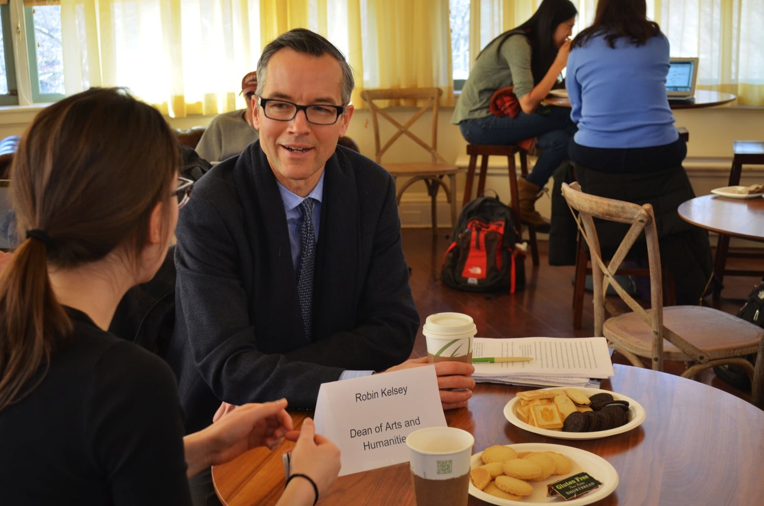 Dean Robin E. Kelsey talks to a student in the Barker Center. Kelsey, the new Dean of Arts and Humanities, held informal office hours for students to chat over free cookies and coffee. 