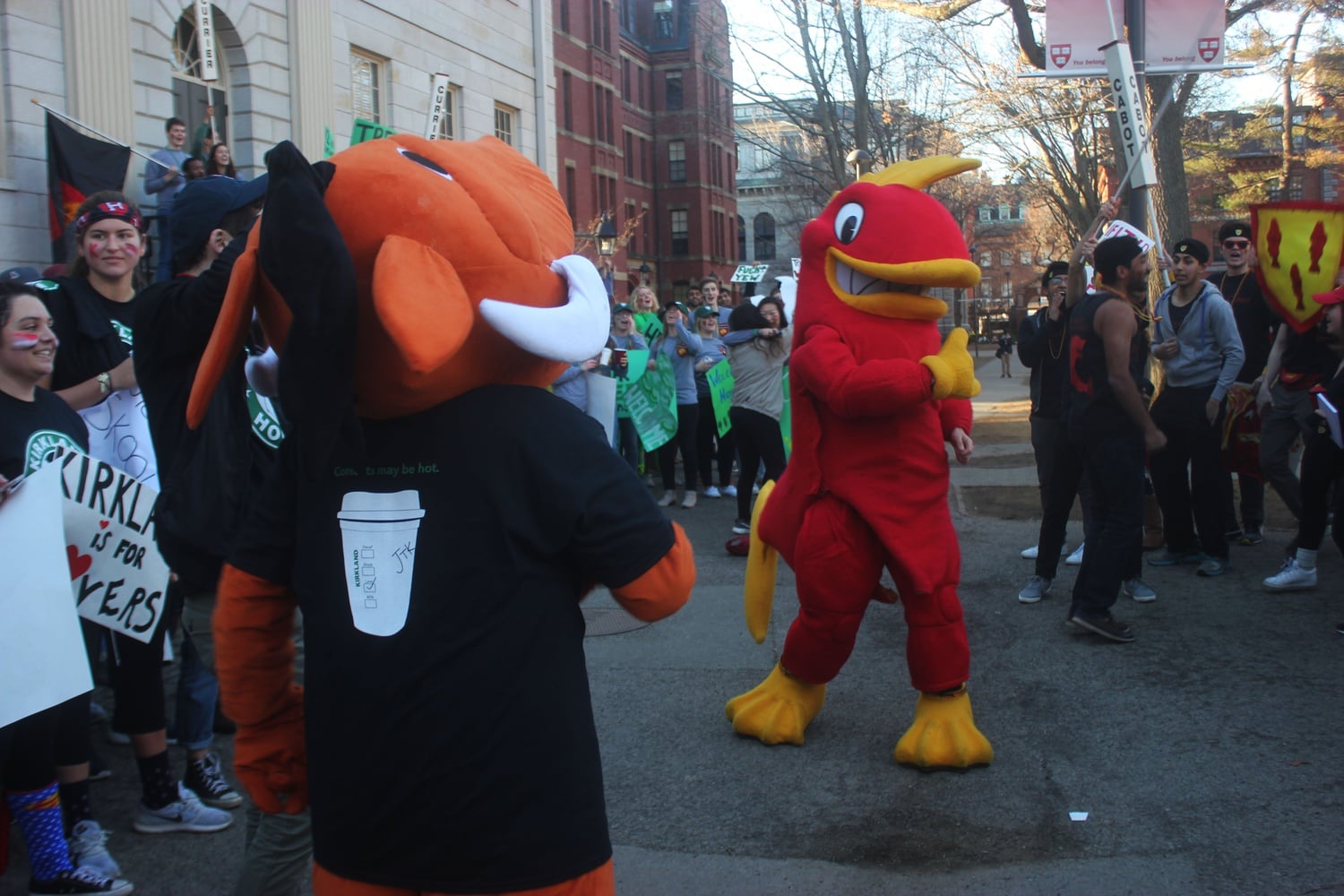 The Cabot and Kirkland mascots prepare for a dance battle in front of the John Harvard statue.