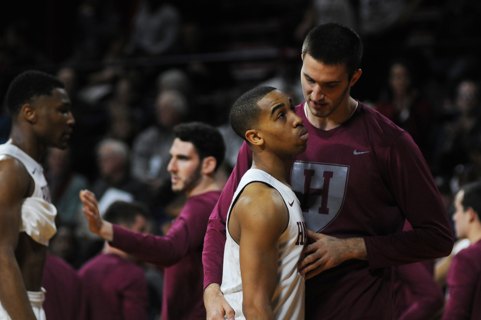 Sophomore forward Balsa Dragovic consoles co-captain Siyani Chambers after the Crimson fell short against the Bulldogs. 