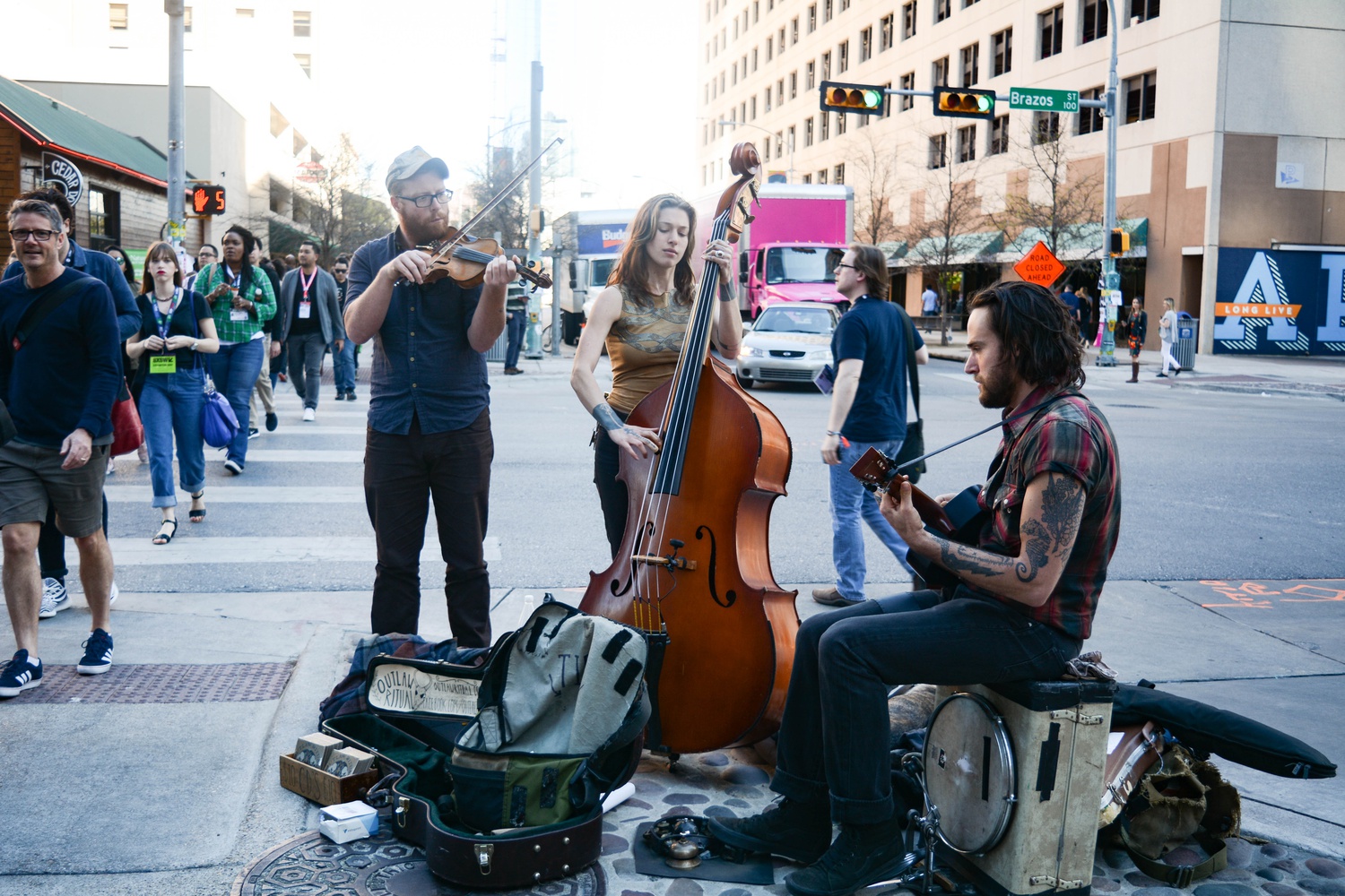 Street performers Outlaw Ritual play on the street leading up to the Austin Convention Center. 