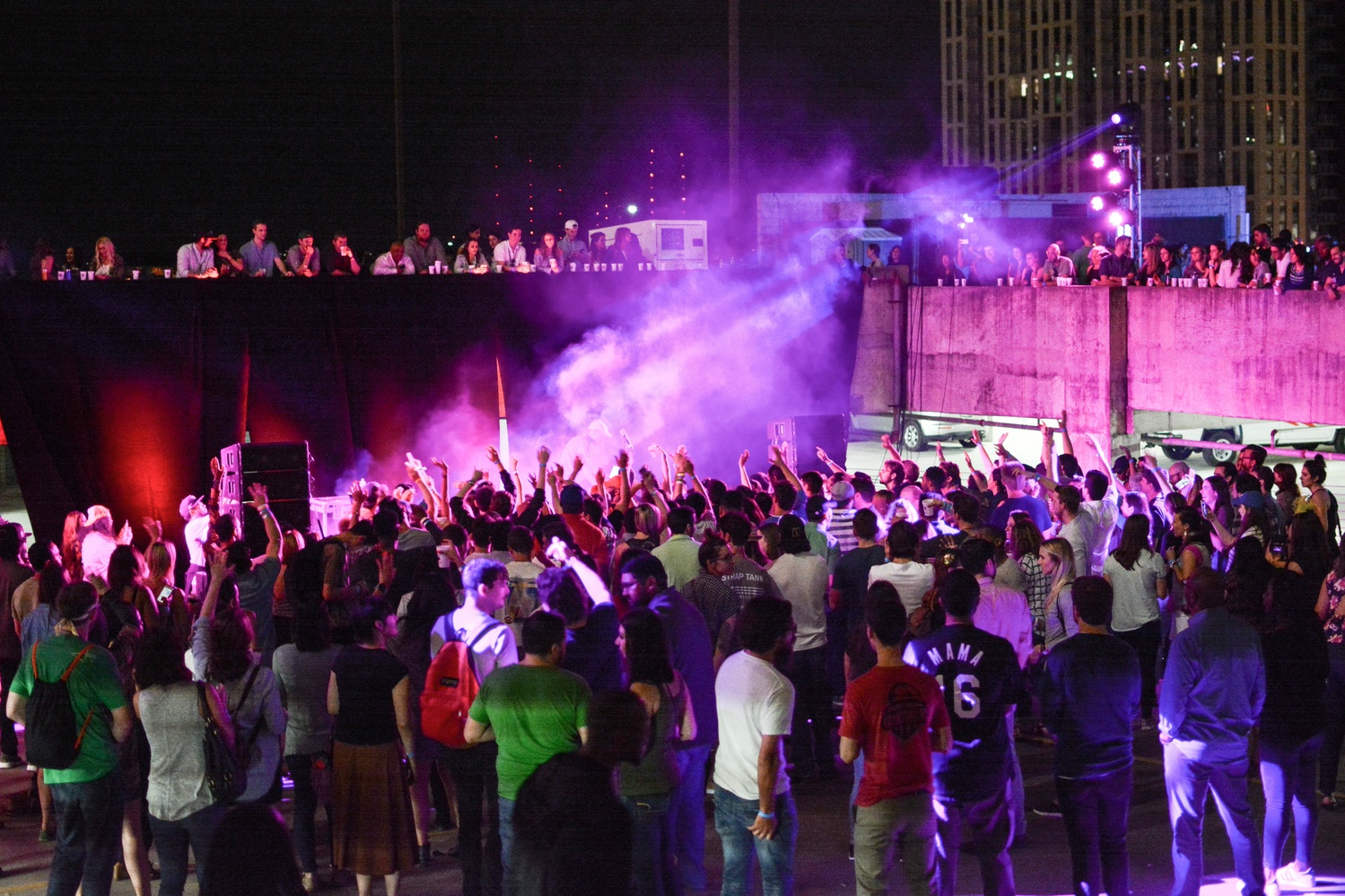 A crowd congregates around up-and-coming rapper Pell at a rooftop concert hosted by Facebook. 