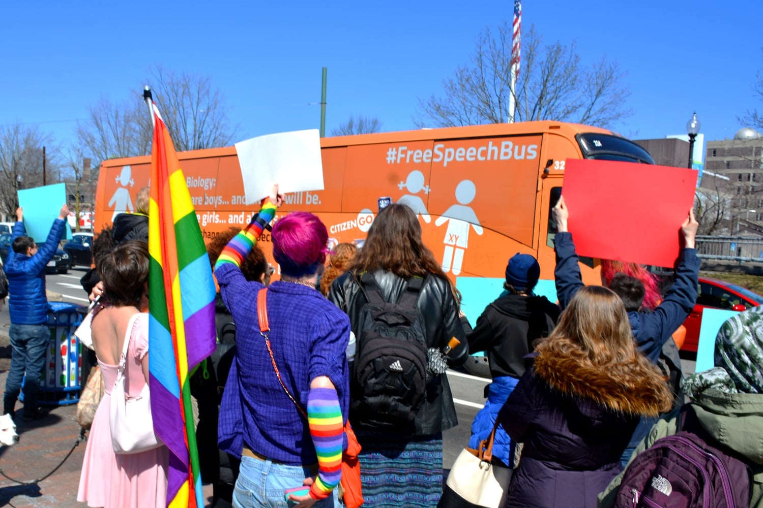 At the junction of Mass. Ave. and Garden St., a group protests the anti-transgender message of the "Free Speech Bus.”