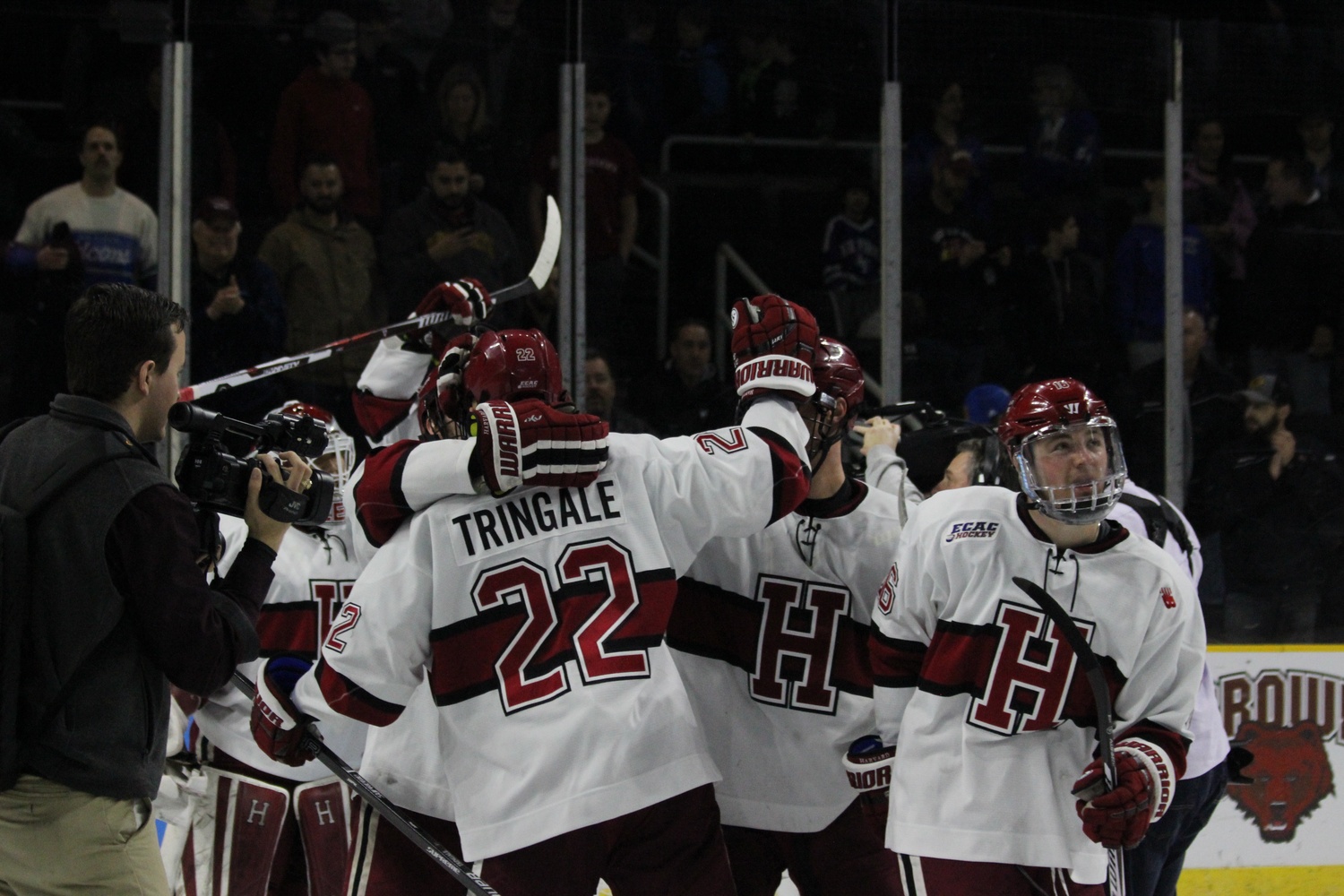 Devin Tringale embraces his teammates in Providence after Harvard's 3-2 win in the East Regional final.