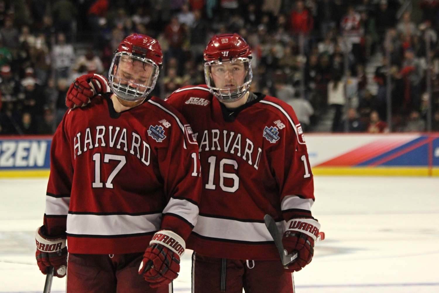 Harvard’s Sean Malone and Ryan Donato tearfully exit the ice following the Crimson’s 2-1 loss to Minnesota-Duluth in the Frozen Four Tournament.