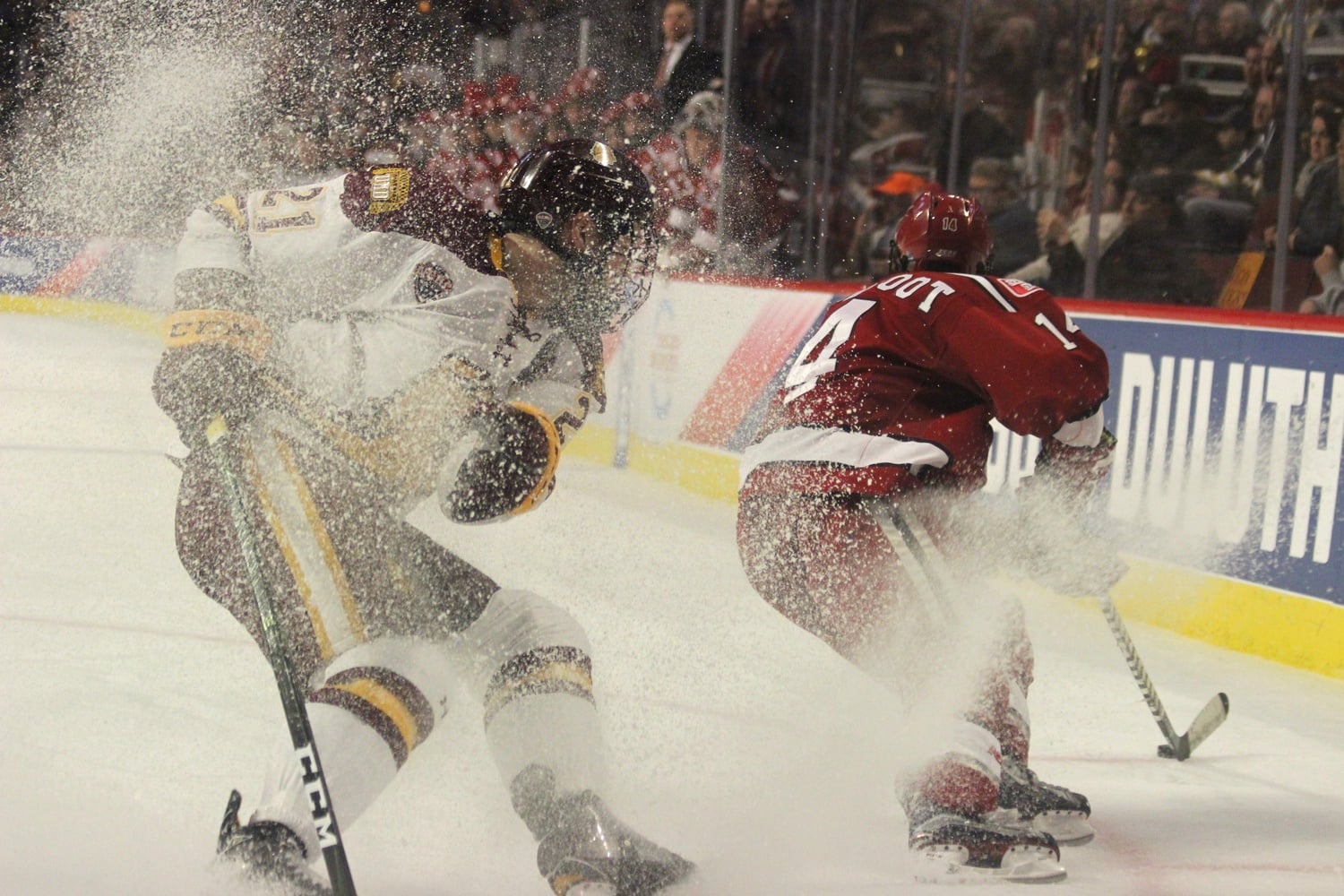 Pivoting on the ice, captains Carson Soucy (Minnesota-Duluth) and Alexander Kerfoot (Harvard).