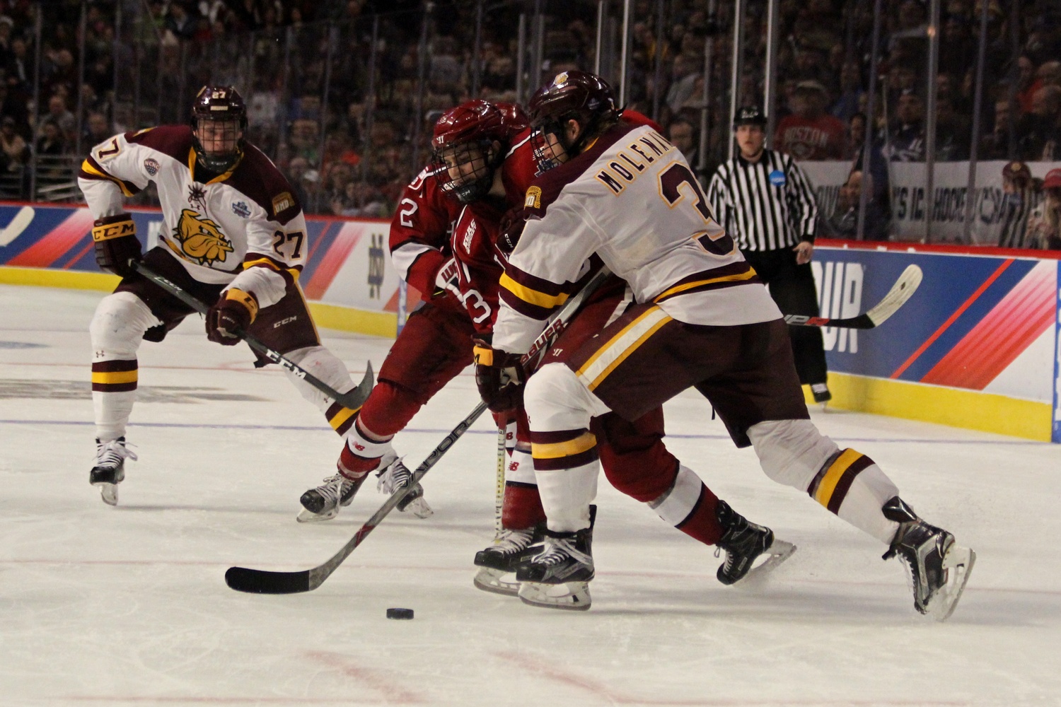 Freshman forward Nathan Krusko meets resistance from Minnesota-Duluth's Dan Molenaar during Thursday's Frozen Four game.