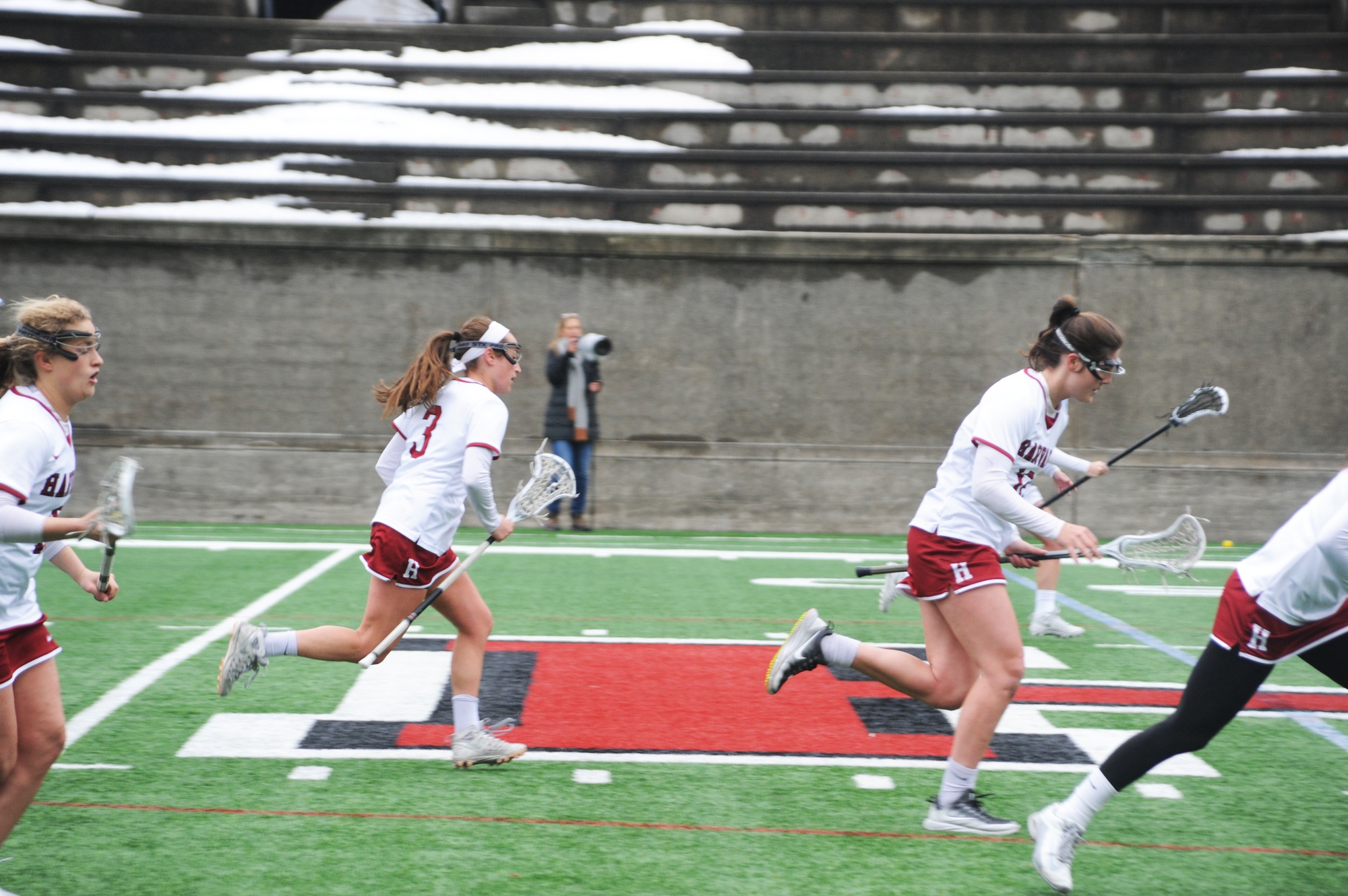 Senior midfeilder Megan Hennessey sprints back on defense in Tuesday night’s match-up. The senior scored two goals in 30 seconds to help solidify the team’s 12-3 lead heading into the half. Hennessey was one of five players to score more than one goal, with three others netting hat tricks.