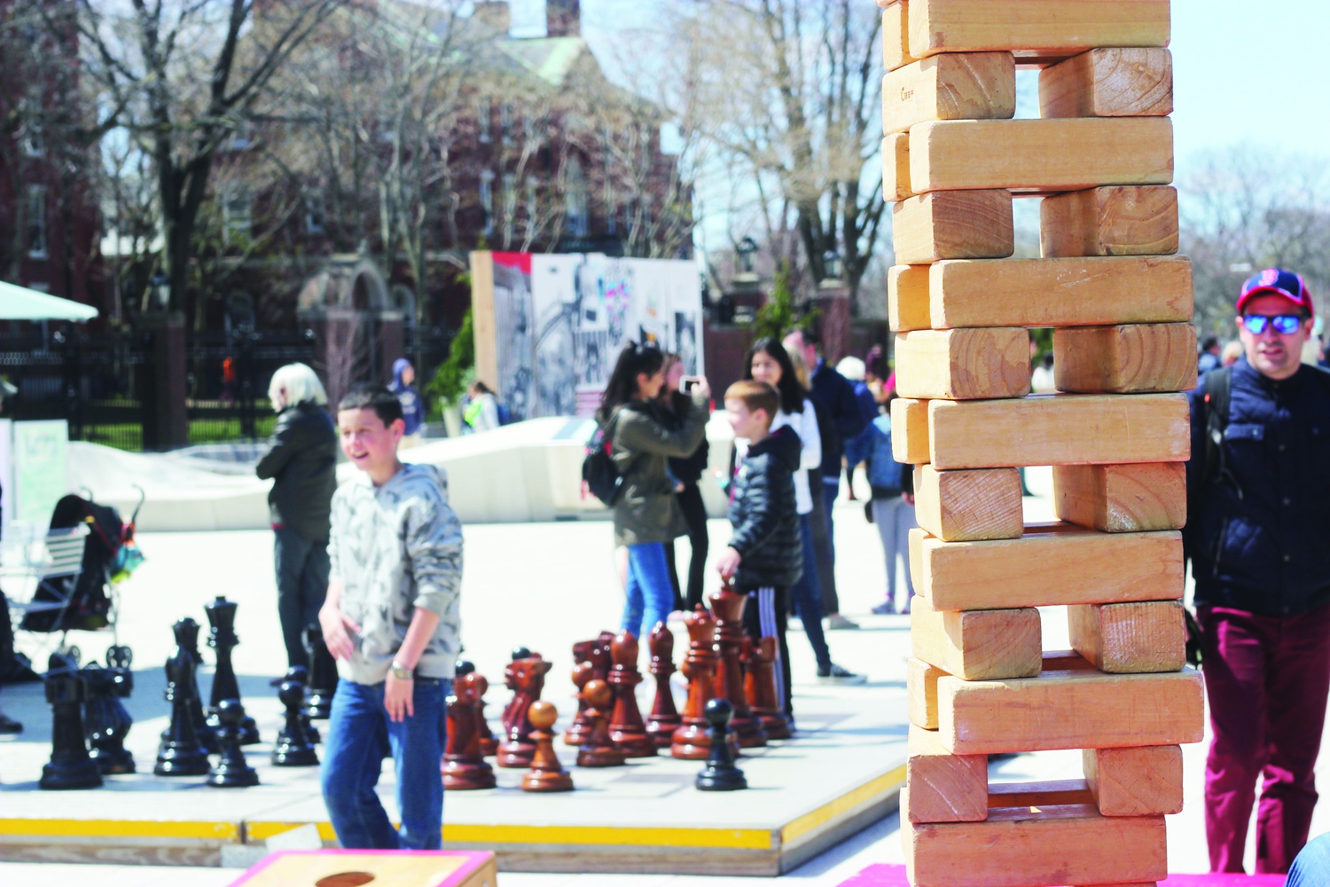 Tourists enjoy lawn games set out on the Science Center Plaza as part of the Harvard Common Spaces initiative. 