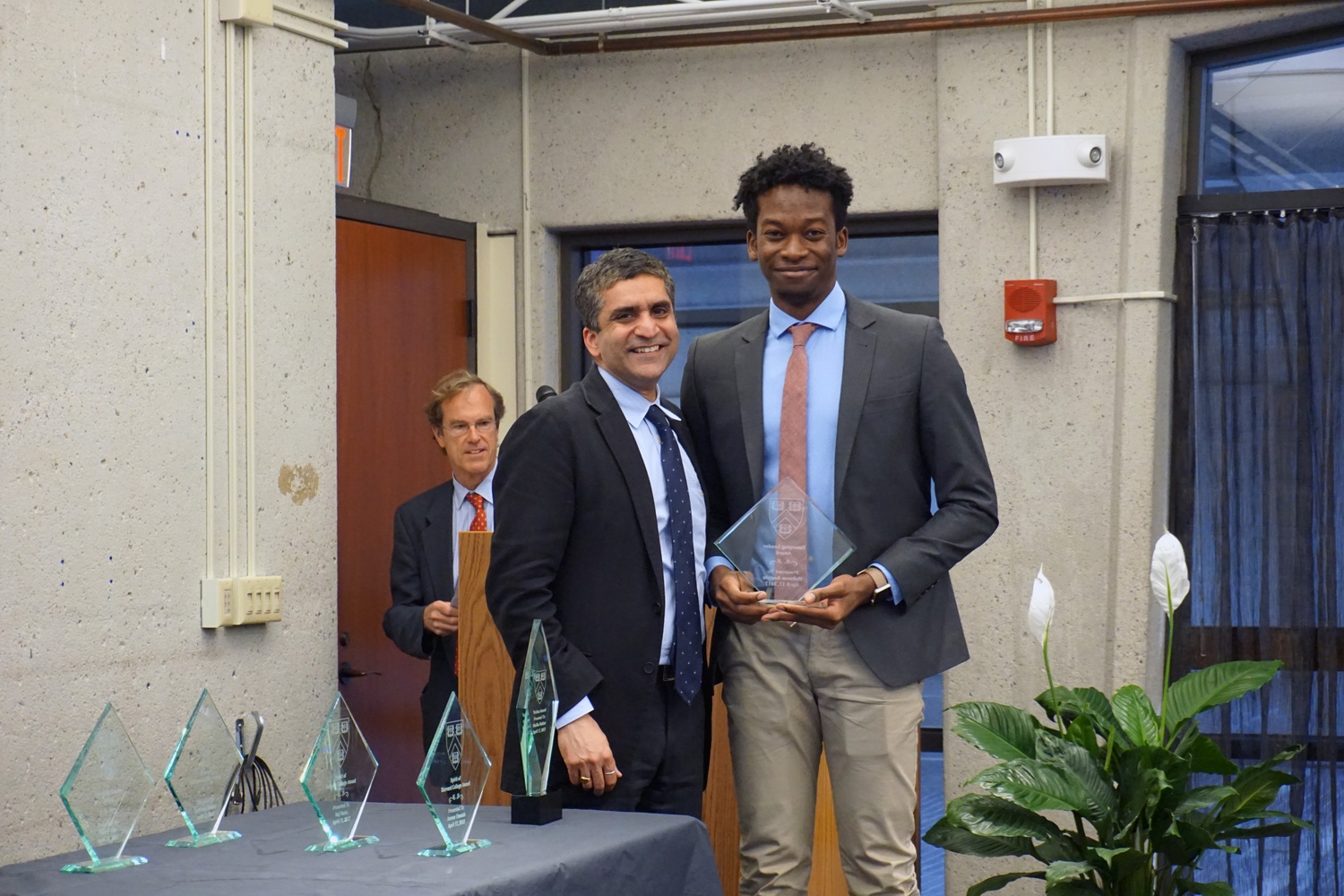 Dean of the College Rakesh Khurana presents Hakeem O. I. Angulu '20 with the Emerging Leader award at the OSL's Student Leadership Recognition Awards at the SOCH. Among many other leadership positions, Angulu is an intern at Harvard Foundation, and was recently elected co-chair of SAC and vice president of Black Students Association.