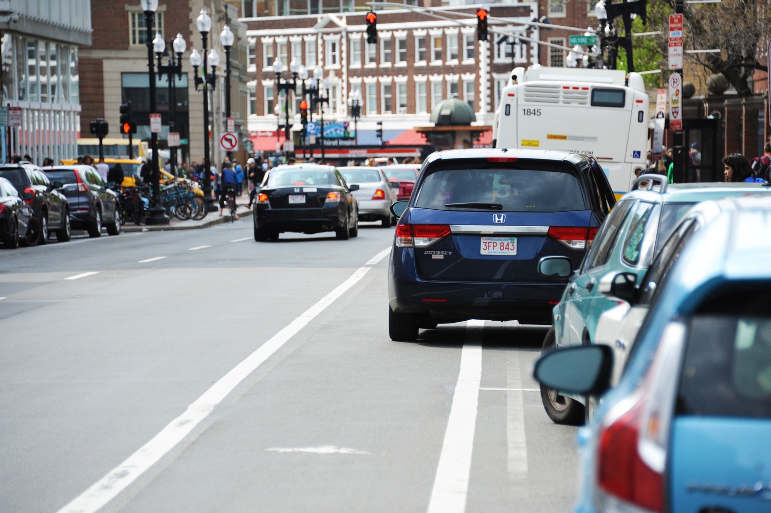 A car double-parked in the bicycle lane on Massachusetts Ave, near Harvard Square.