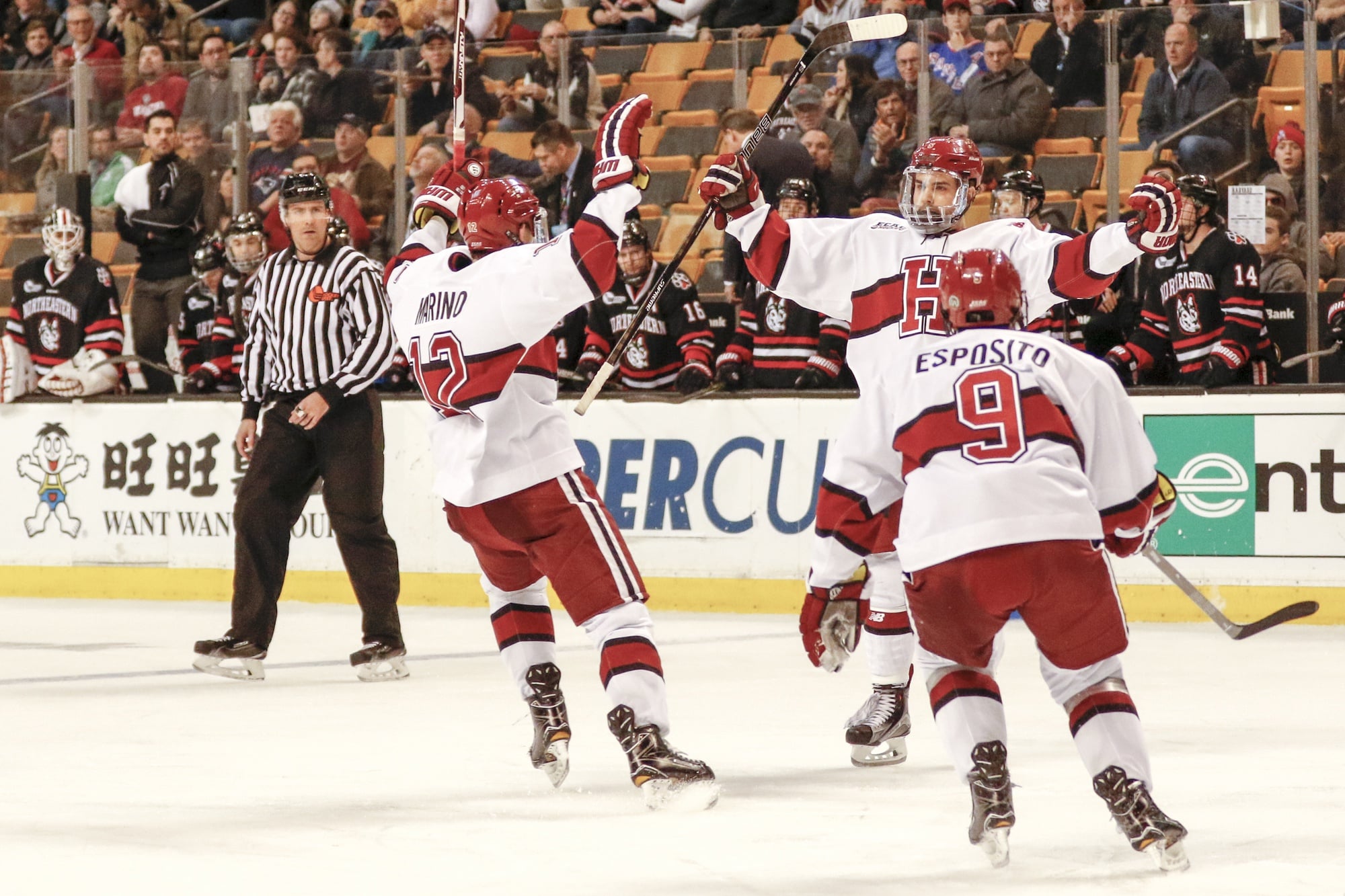 Crimson players exult after a goal in the first round of the Beanpot against Northeastern.