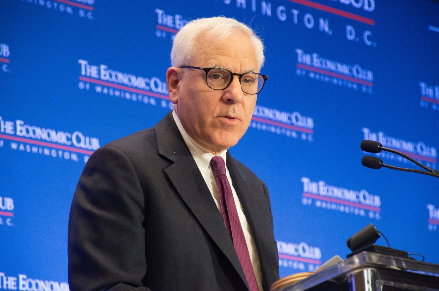 David M. Rubenstein, pictured speaking at the Economic Club of Washington, D.C., will depart from the Harvard Corporation in June after a six-year tenure.