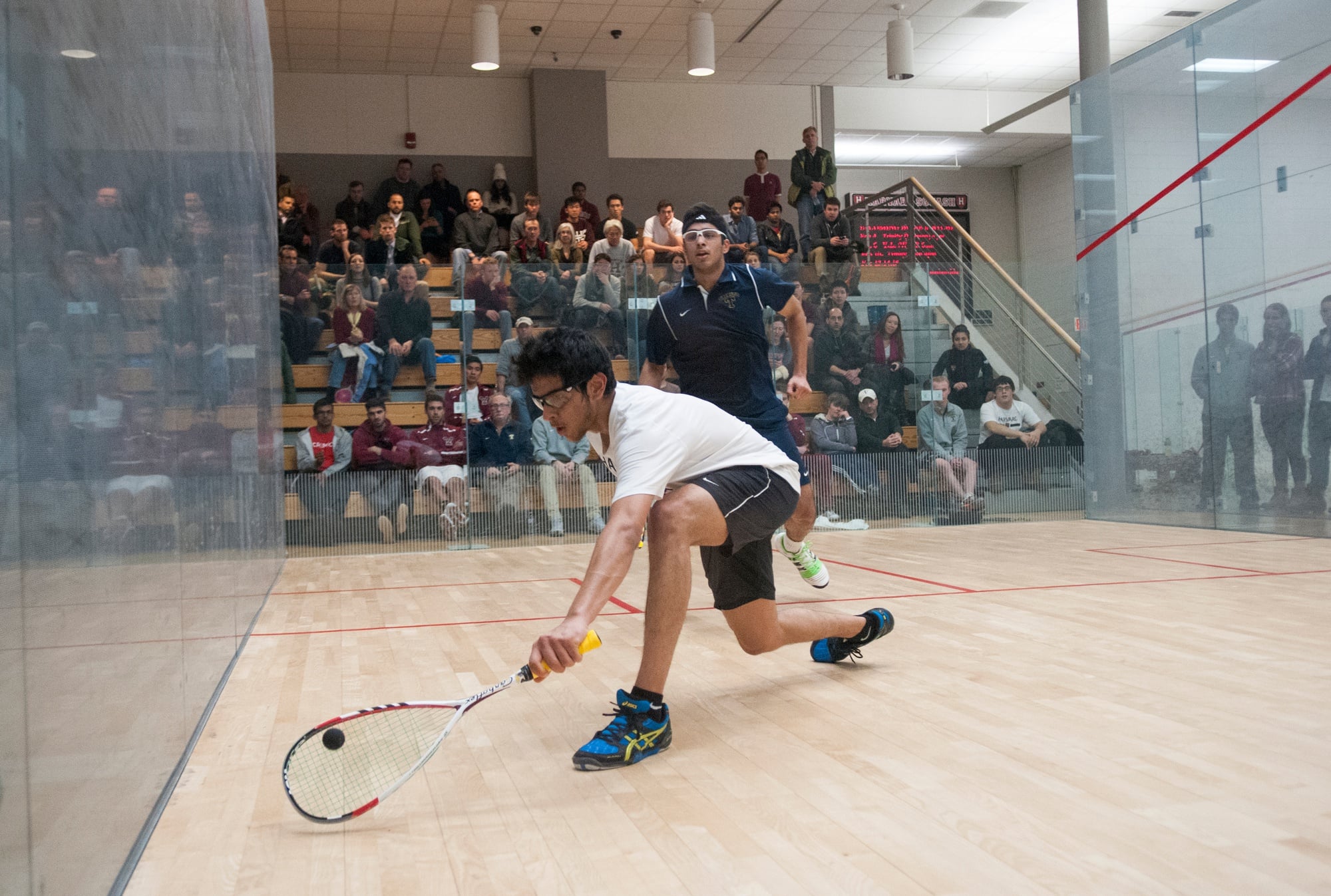 Madhav Dhingra, now a junior, lunges for a shot in a 2015 match against Trinity.