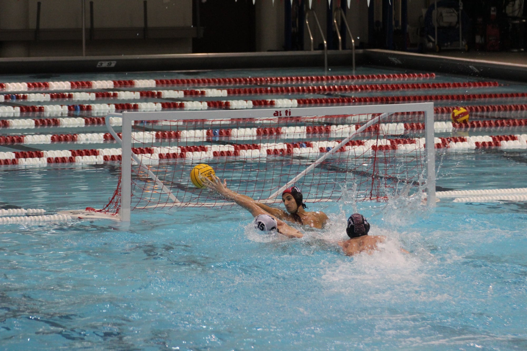 Freshman goalie Nikhil Suri extends his arms to block a shot against MIT.