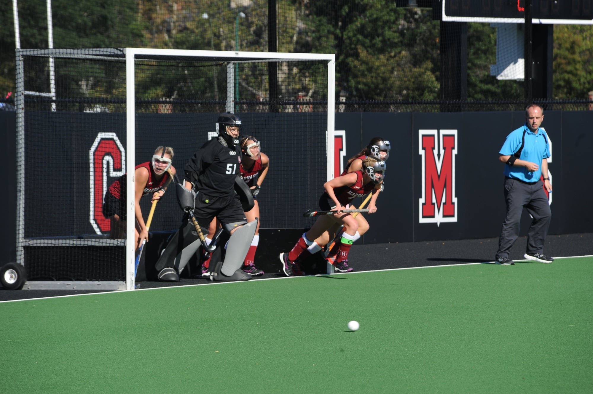 A cohort of defenders tries to stop a penalty corner. The Crimson let up two second-half goals but clamped down in overtime.