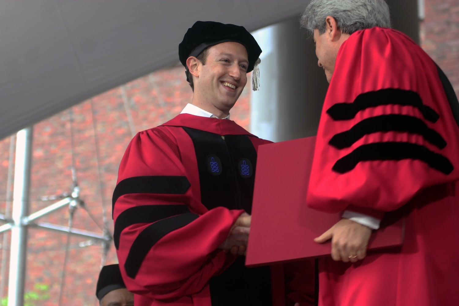 Mark E. Zuckerberg receives his honorary Doctor of Laws degree from Marc L. Goodheart '81, the vice-president and secretary of the University, at Morning Exercises.