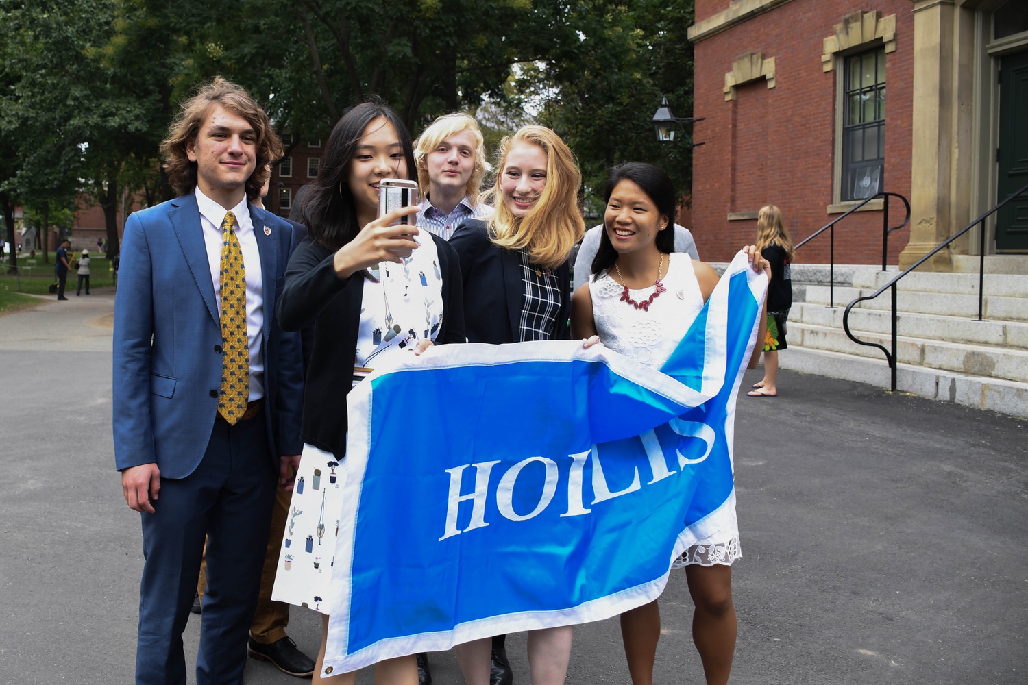 Residents of Hollis Hall pose for a selfie in the Yard as they proceed towards Convocation