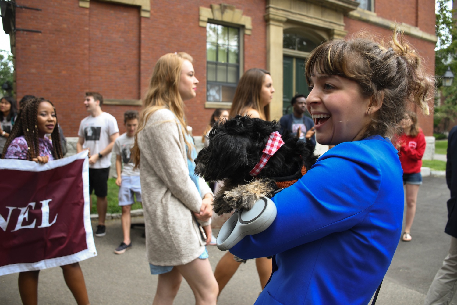 Alexa Kutler, a proctor in Hollis Hall, brought along her dog to cheer on freshmen as they process towards Convocation.