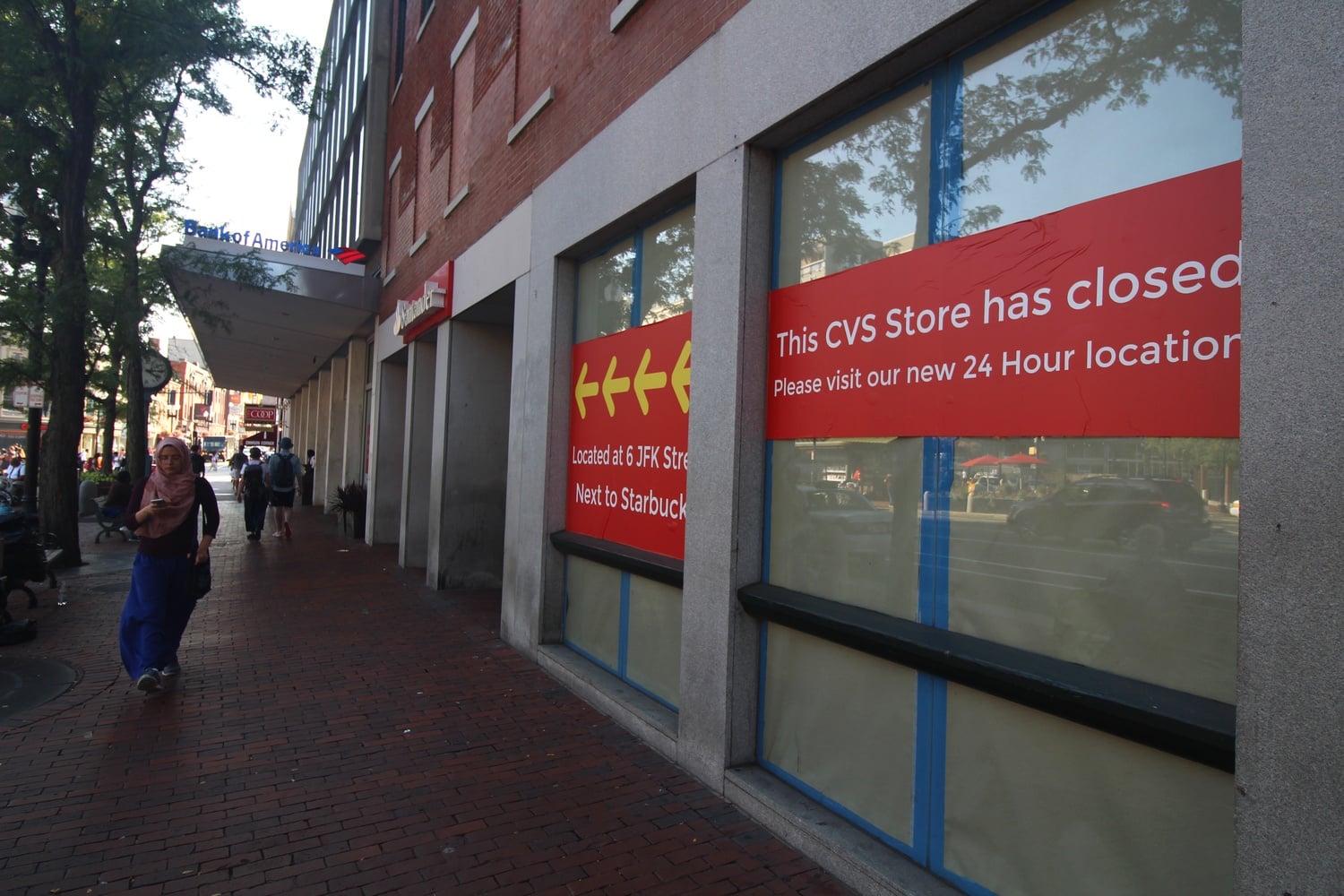 A pedestrian passes the recently-closed CVS store on Massachusetts Avenue.
