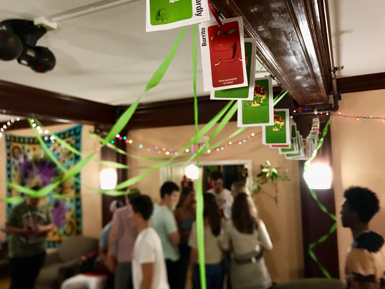 Students talk and dance during an apple-themed party at Bowdoin's Reed House—formerly Chi Psi.