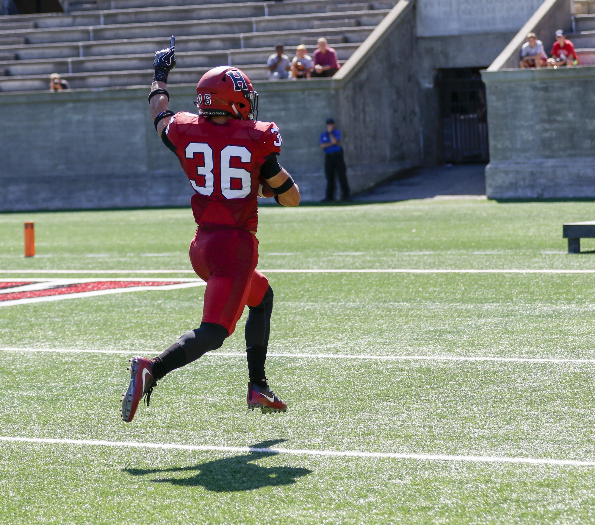 Safety Tanner Lee skips into the end zone after hauling in a first-half interception. The senior spearheaded a defense that collected three picks.