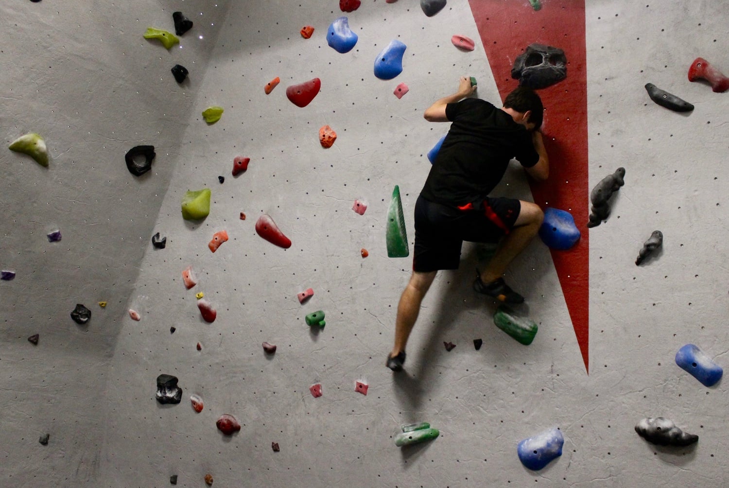 Jack W. Deschler '19 uses the climbing wall in the basement of the Quadrangle Recreational Athletic Center on Tuesday night.